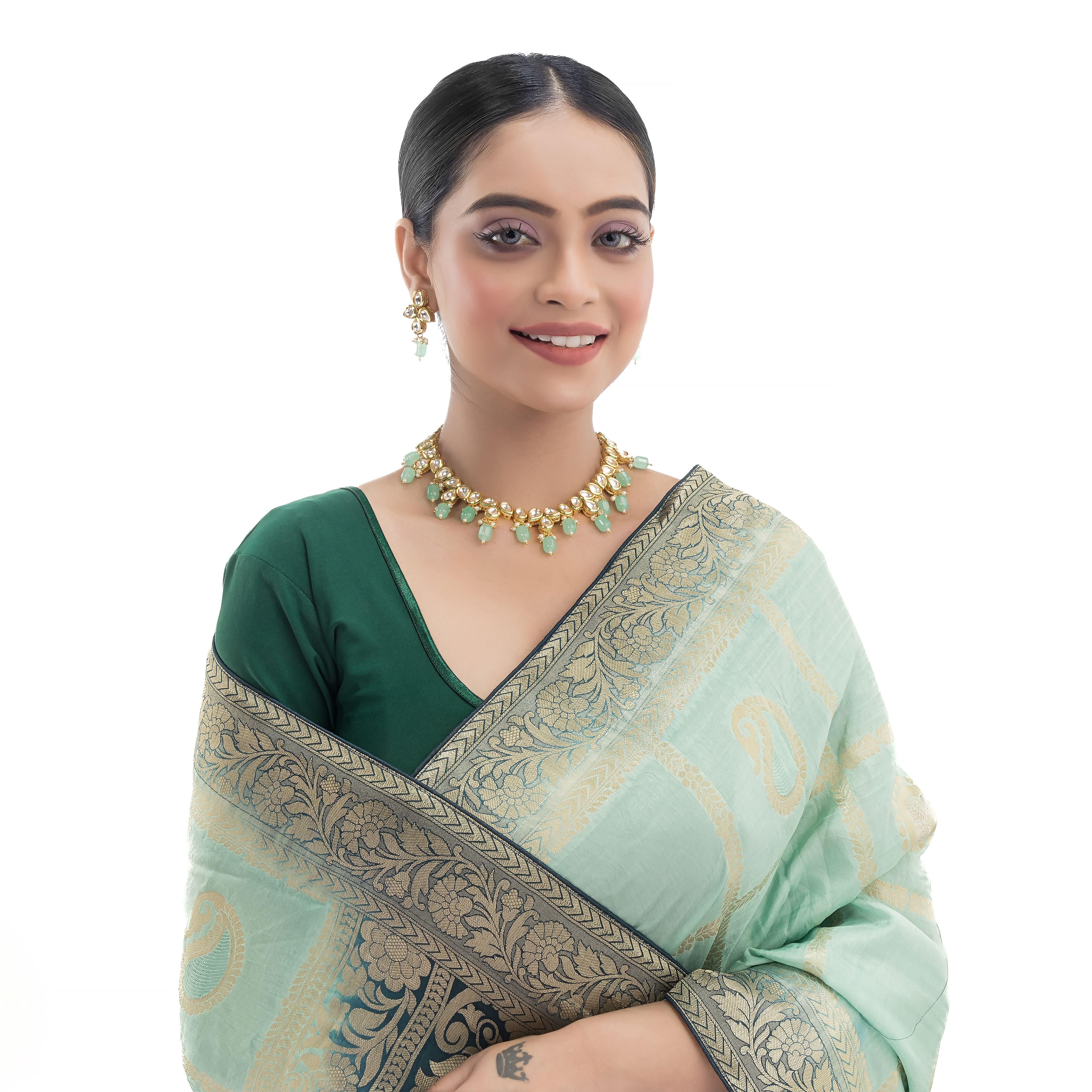 "Light green kundan necklace radiates vibrant, elegant charm."