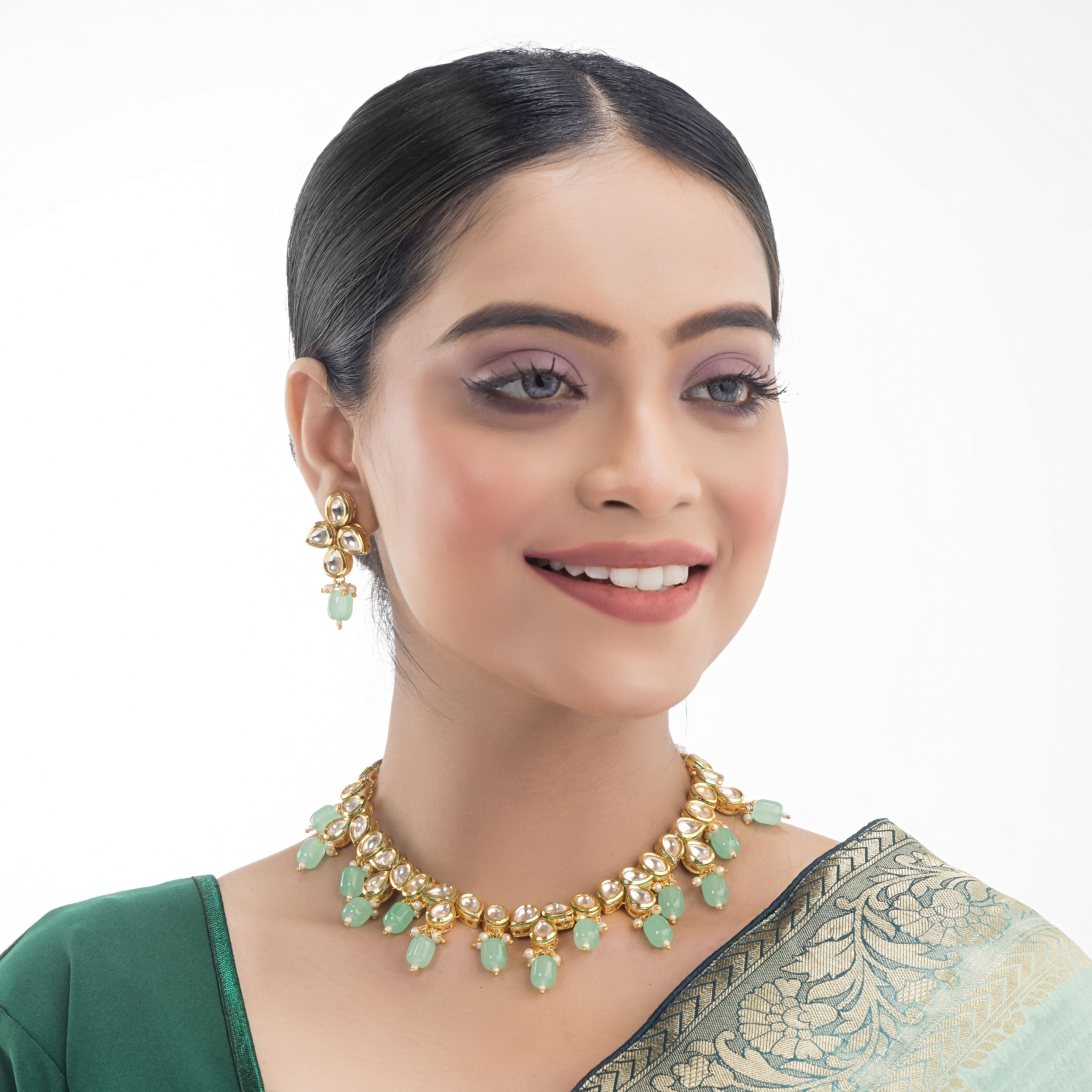 "Light green kundan necklace radiates vibrant, elegant charm."