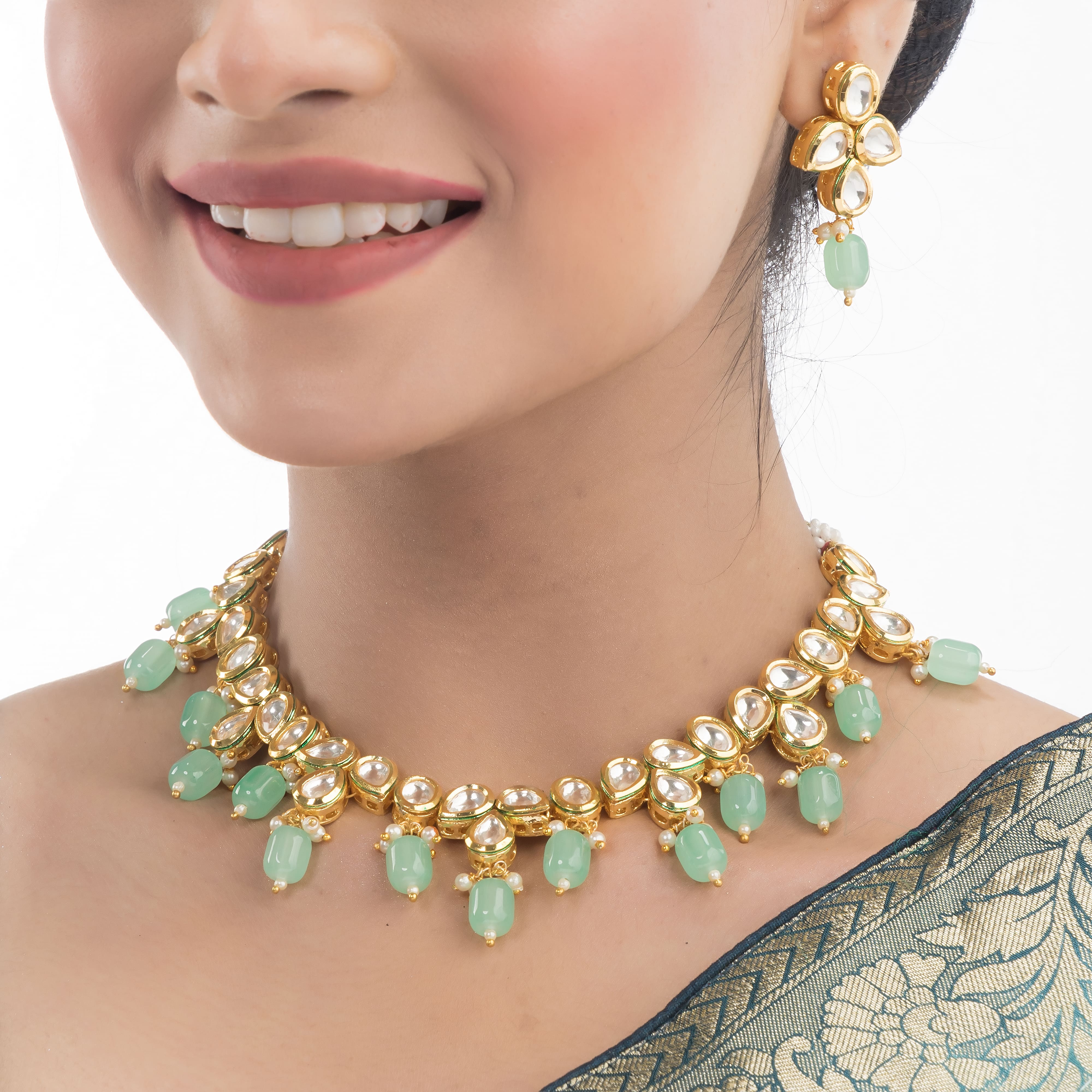 "Light green kundan necklace radiates vibrant, elegant charm."