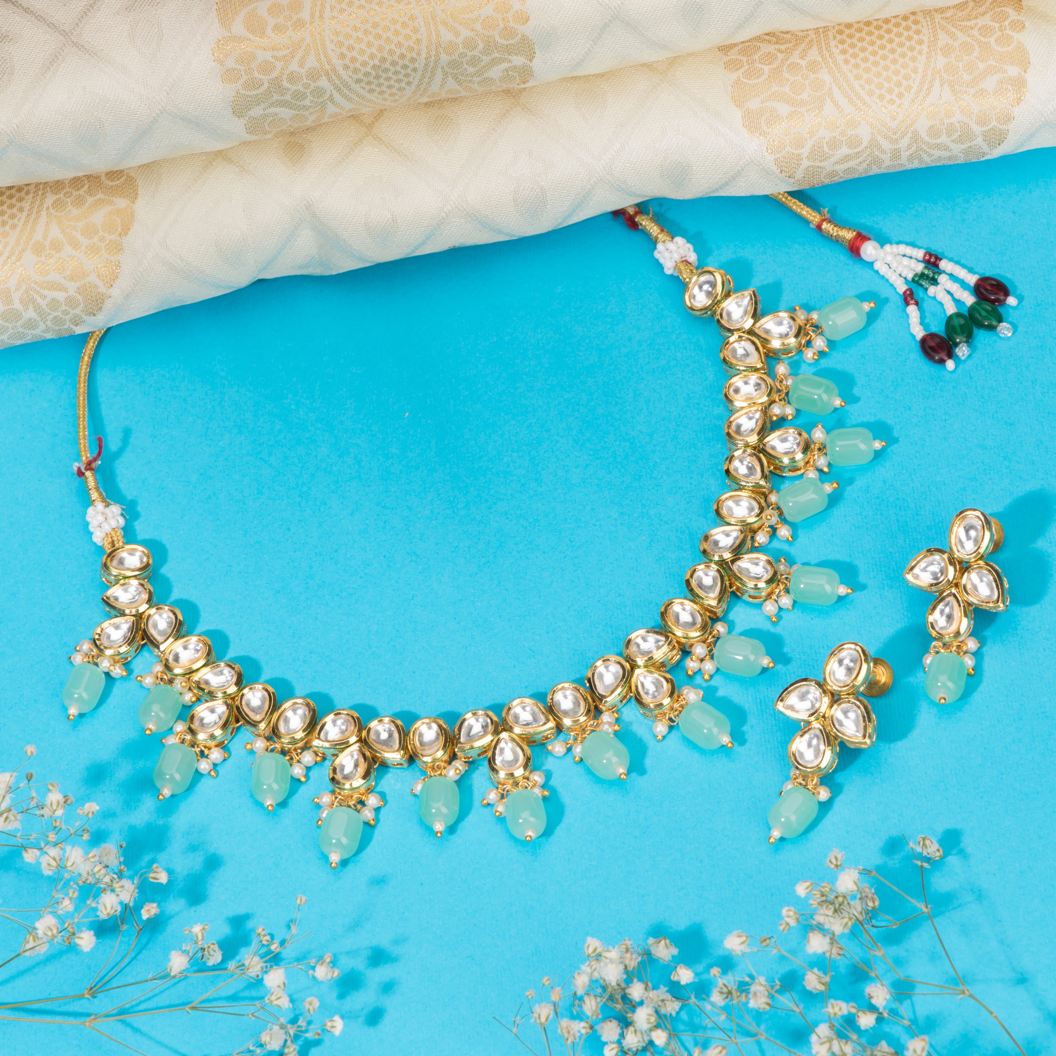 "Light green kundan necklace radiates vibrant, elegant charm."
