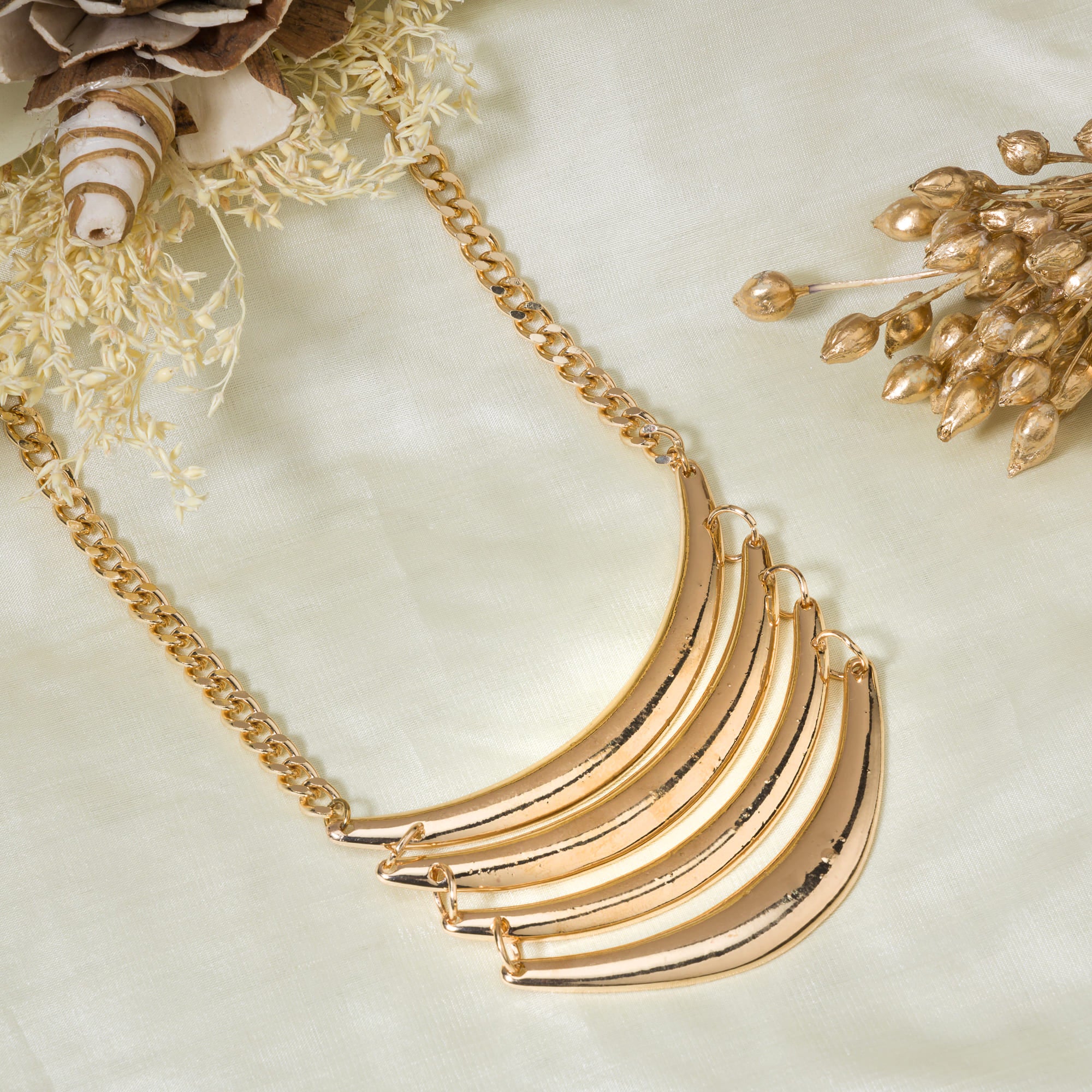 "Trendy gold-tone necklace adds a chic touch to any casual look."