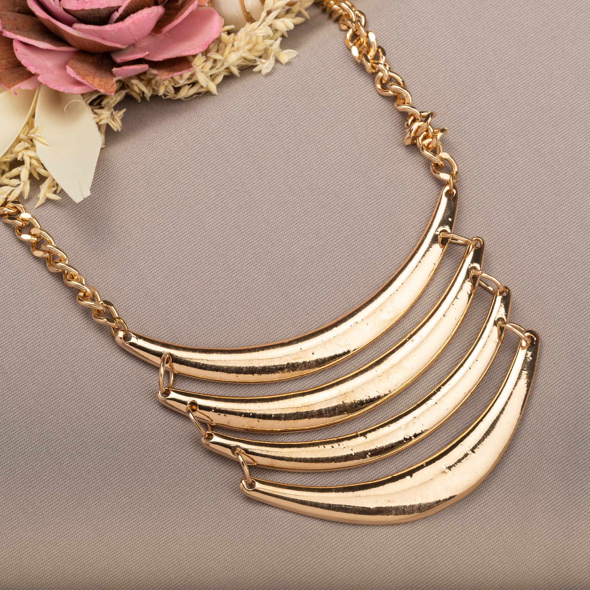 "Trendy gold-tone necklace adds a chic touch to any casual look."