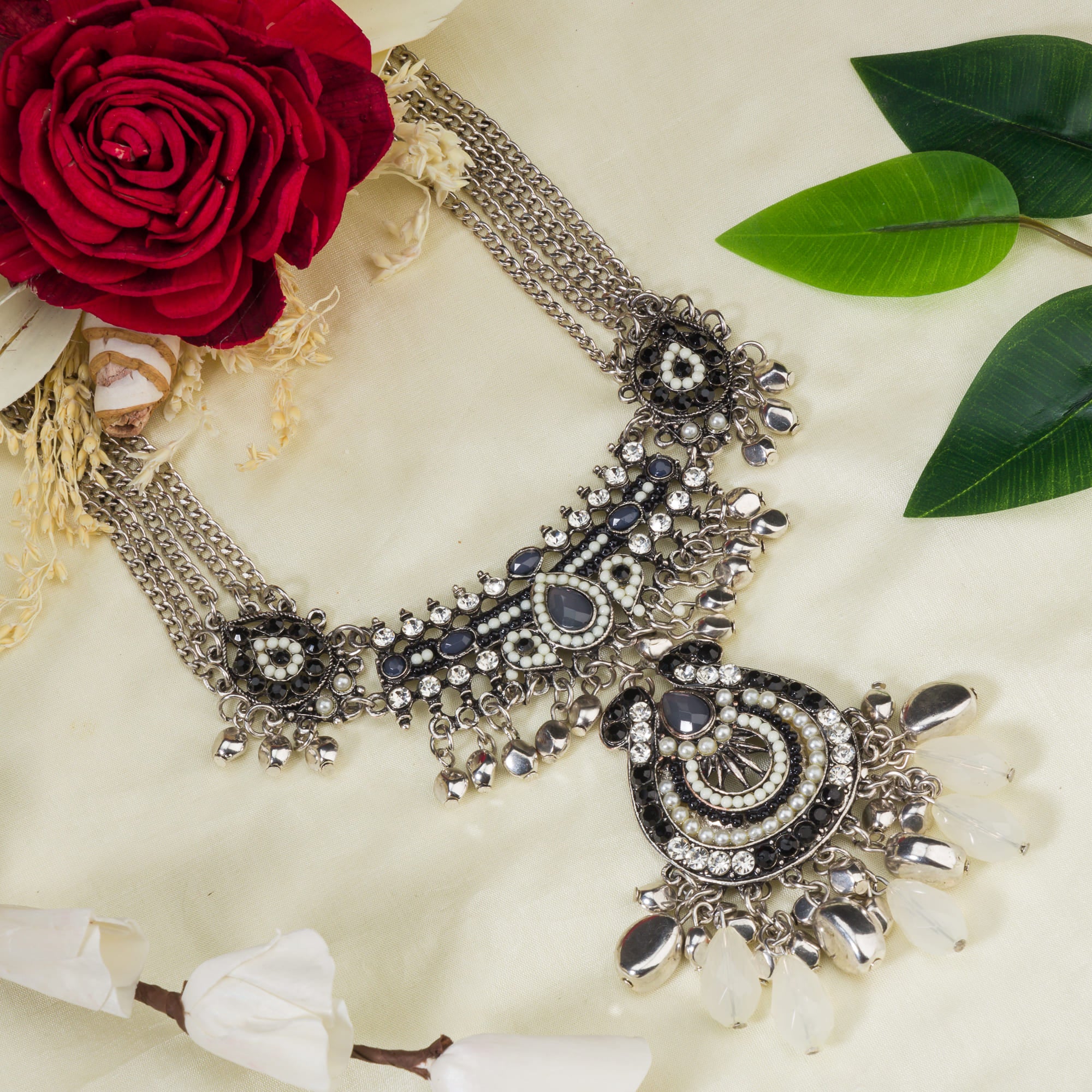 "Oxidized silver necklace with black and white beads adds stylish contrast."