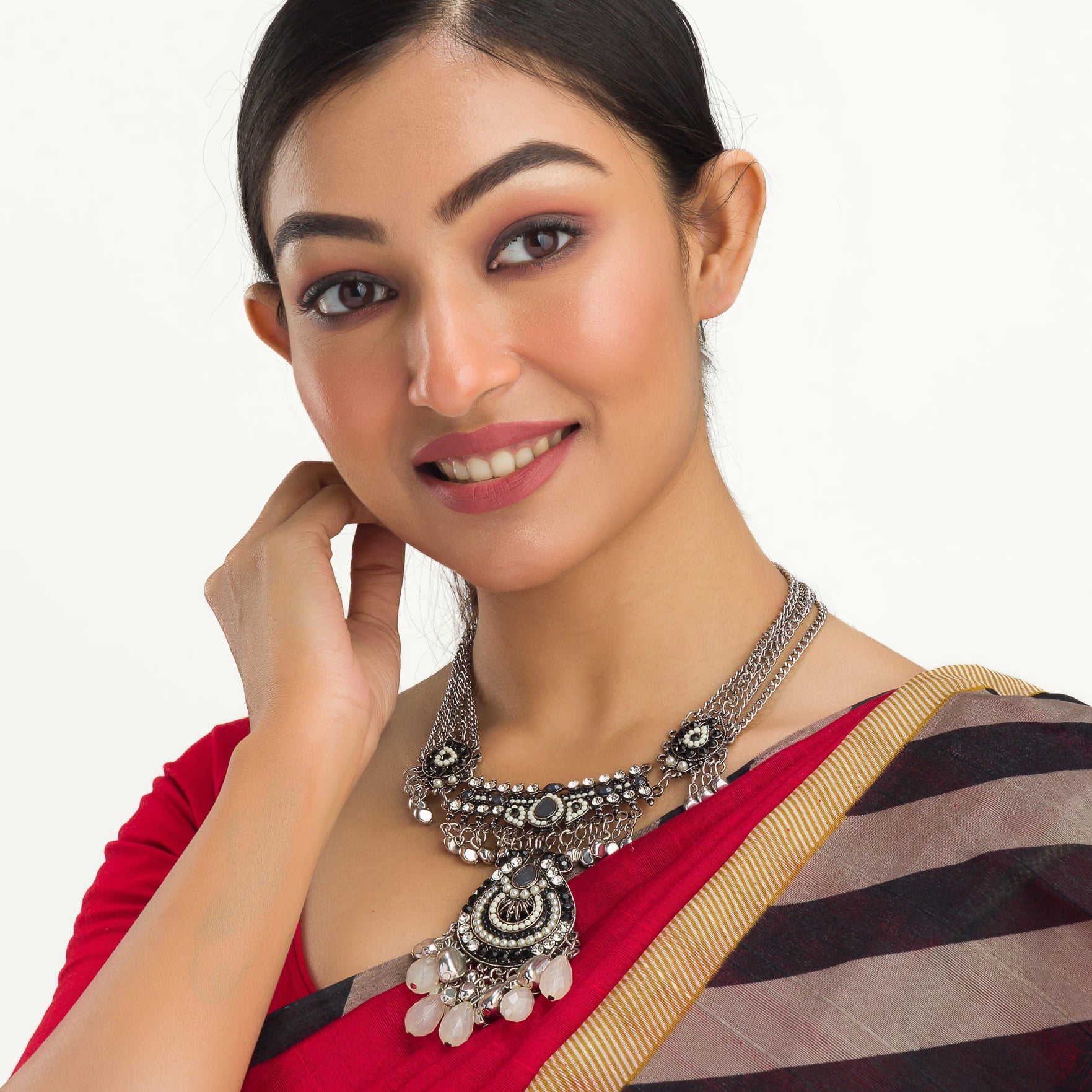 "Oxidized silver necklace with black and white beads adds stylish contrast."