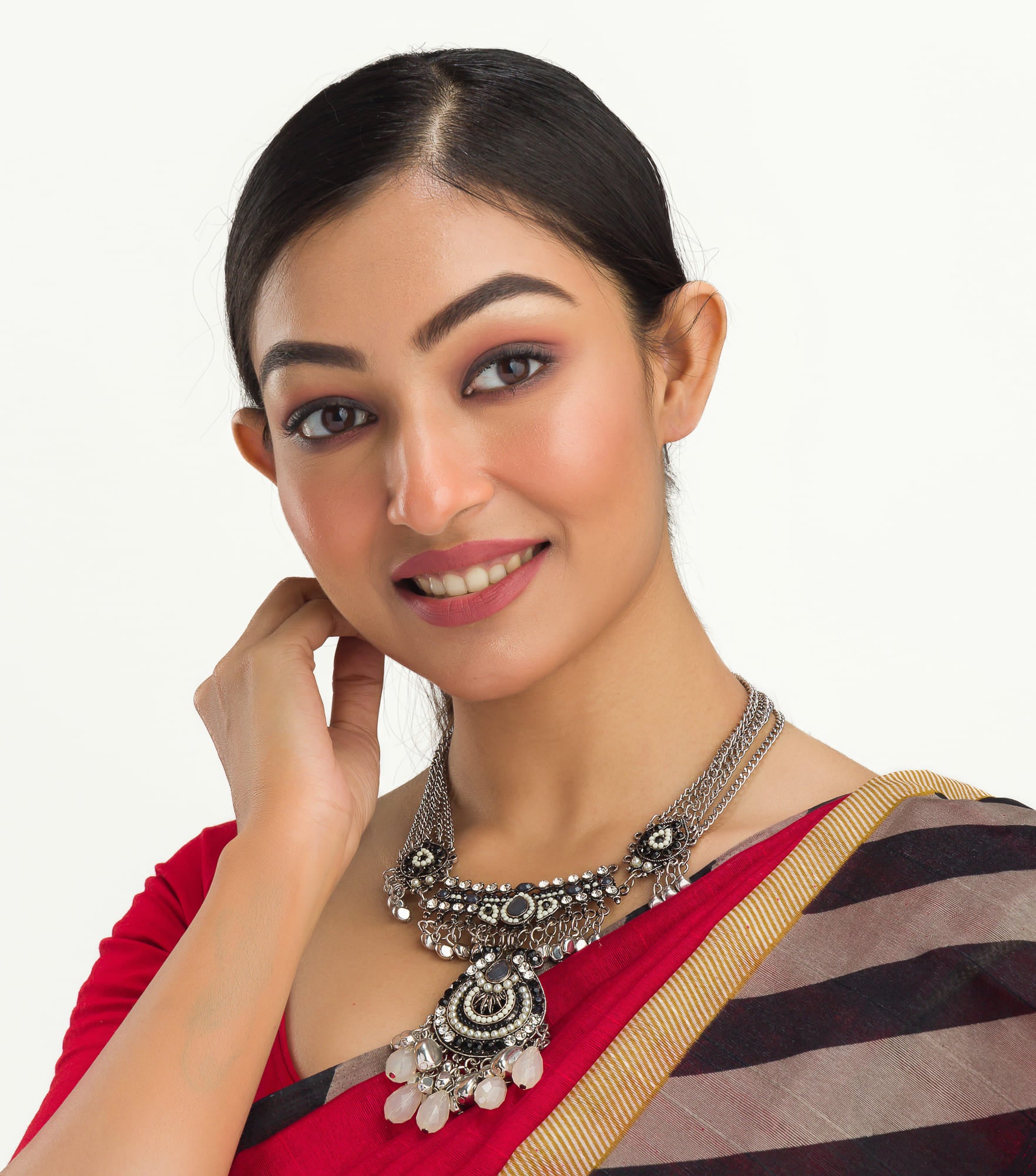 "Oxidized silver necklace with black and white beads adds stylish contrast."