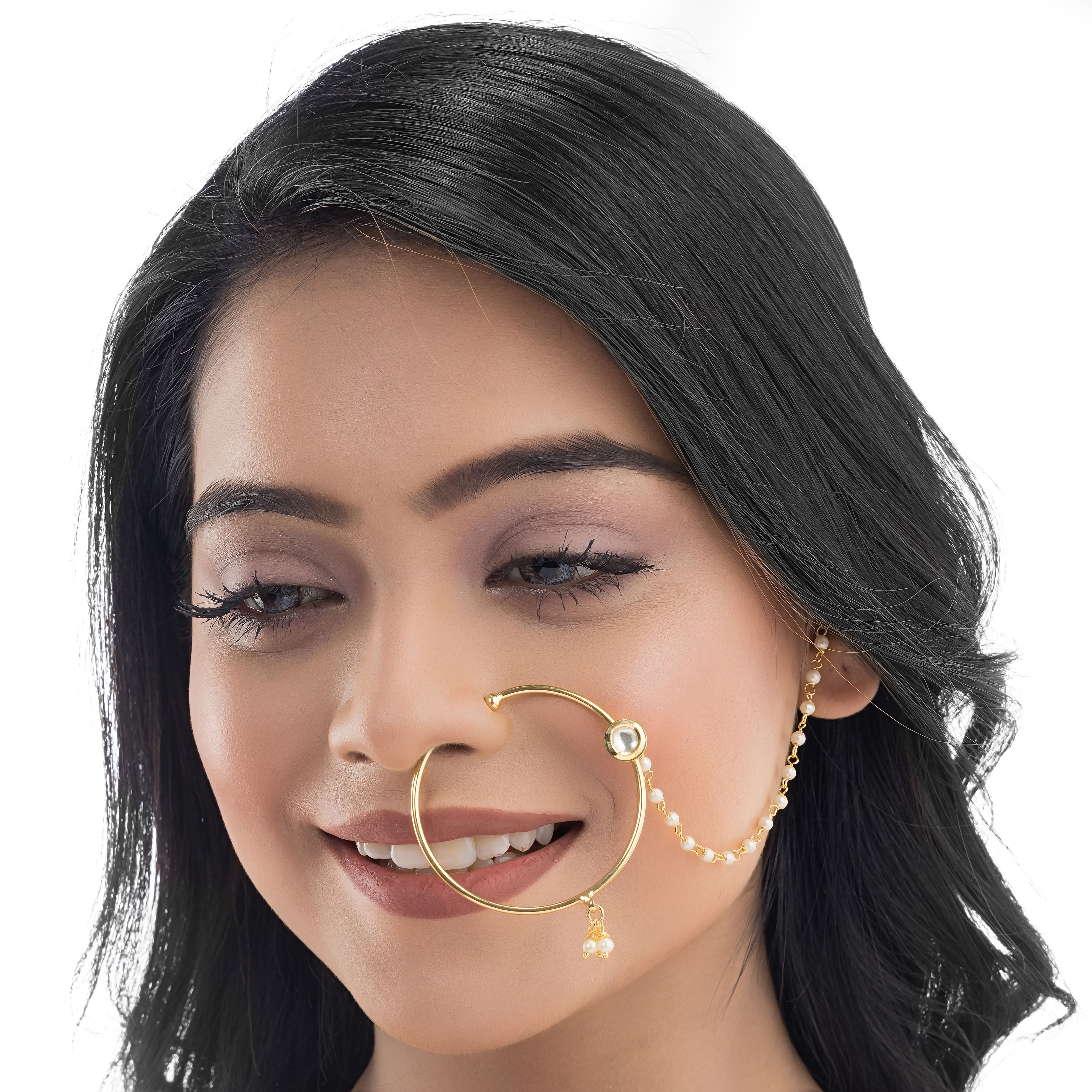 "Gold-polish nath with white pearls offers classic, elegant charm."