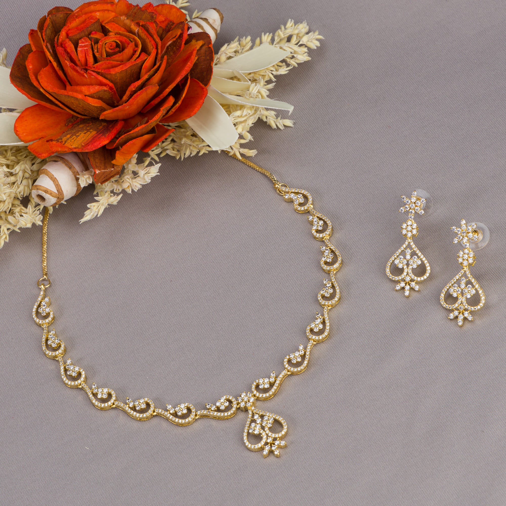 Small S-shaped zircon necklace with gold polish offers delicate elegance and subtle sparkle.