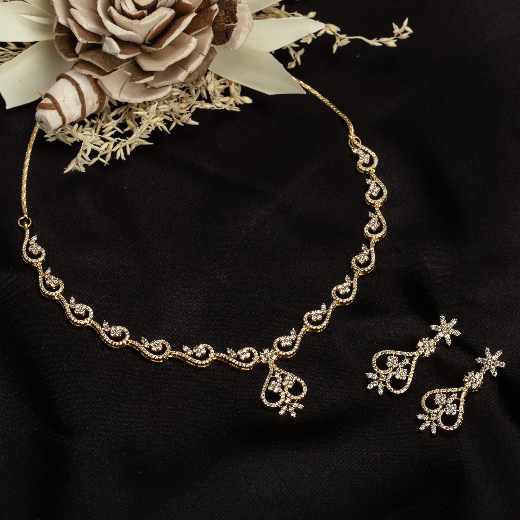 Small S-shaped zircon necklace with gold polish offers delicate elegance and subtle sparkle.