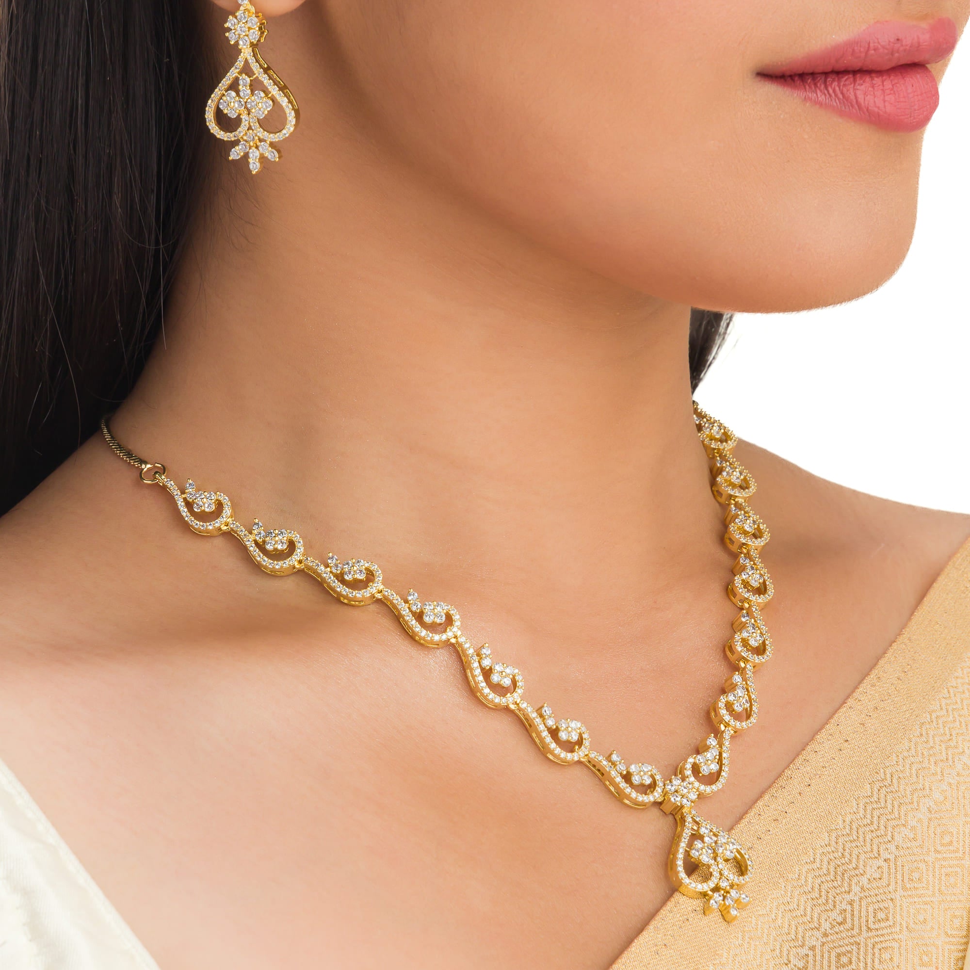 Small S-shaped zircon necklace with gold polish offers delicate elegance and subtle sparkle.