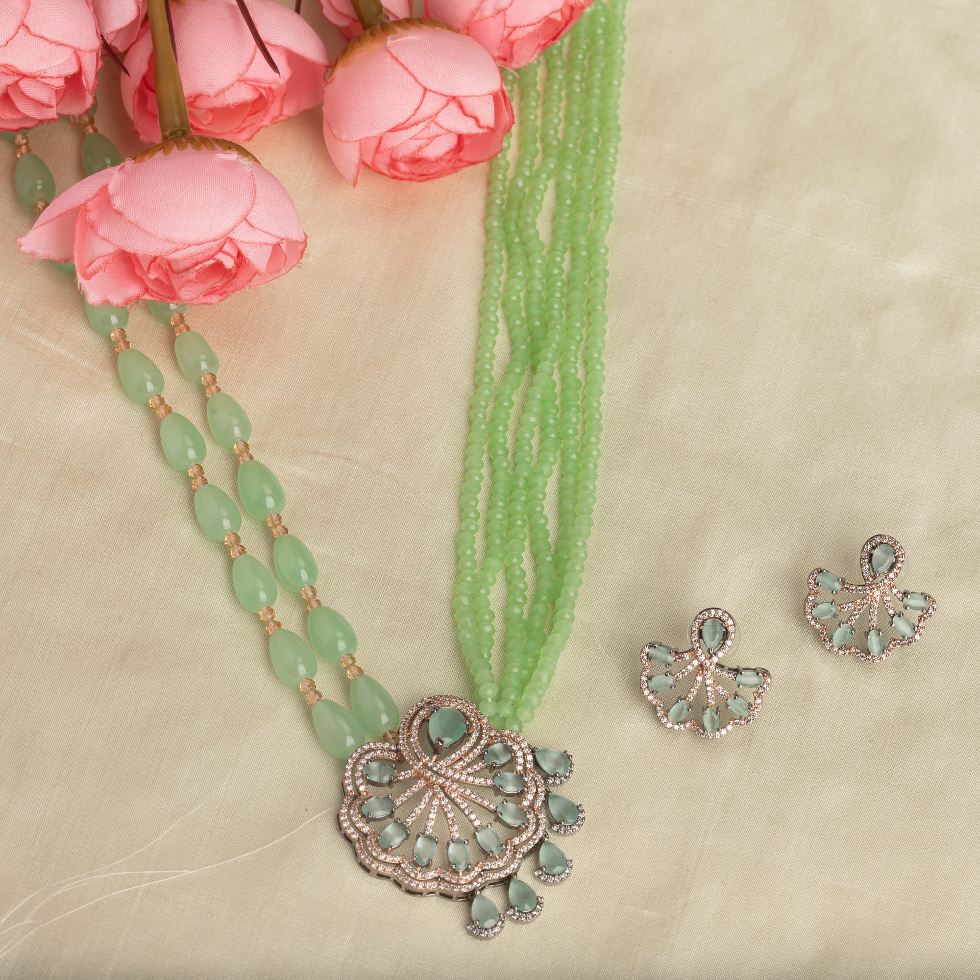 "Light green pearl long necklace in rose gold for a fresh, elegant look."