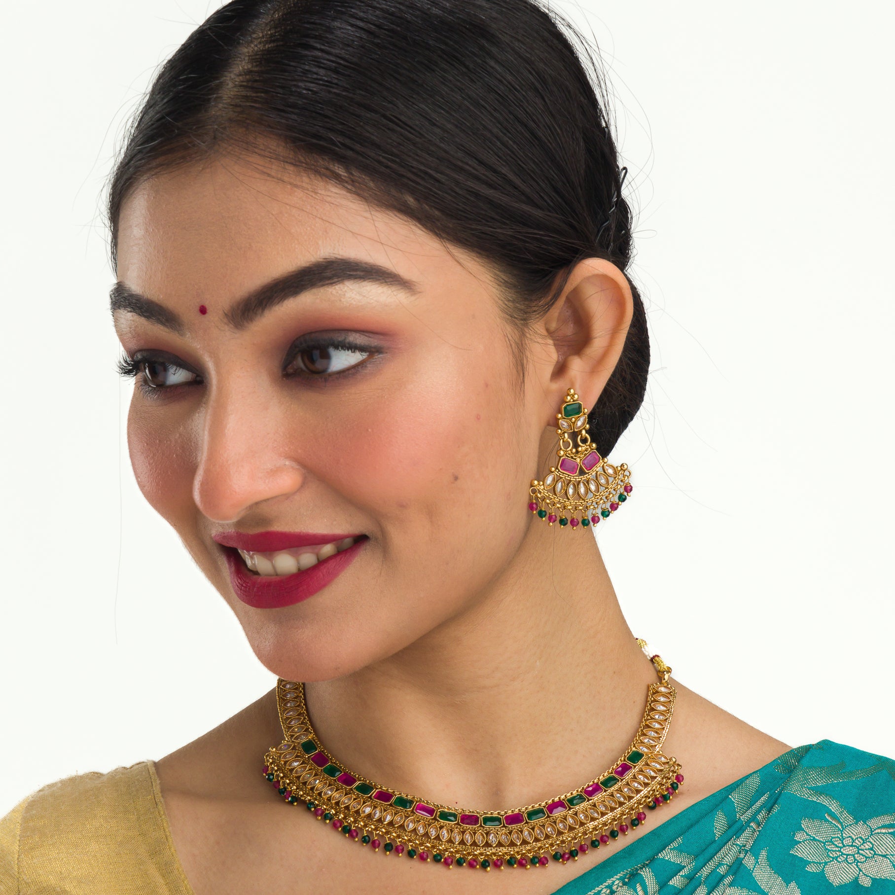 "Gold-tone necklace with multi-color stones adds vibrant style and festive charm."