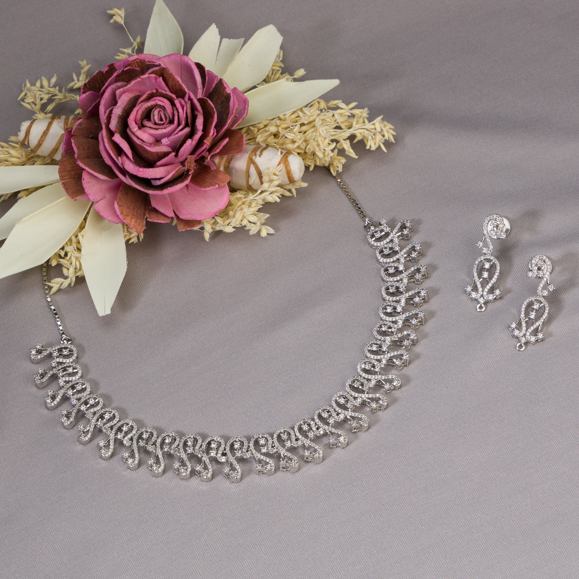 S-shaped zircon design offers sleek, flowing elegance for a refined style.