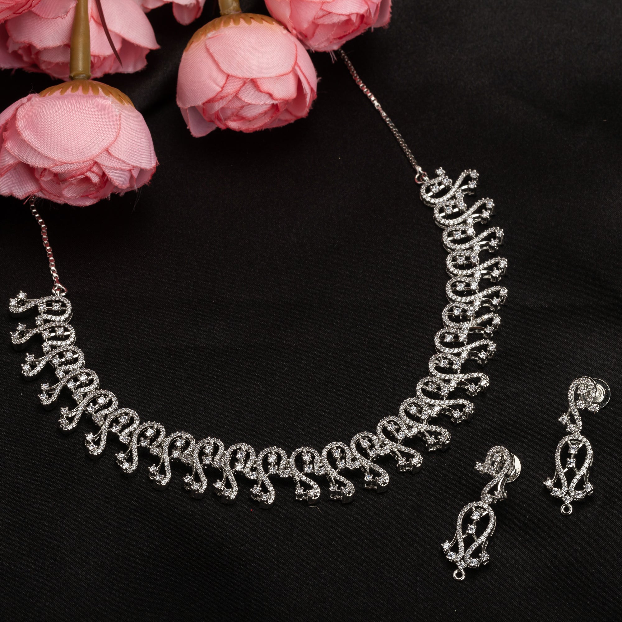 S-shaped zircon design offers sleek, flowing elegance for a refined style.