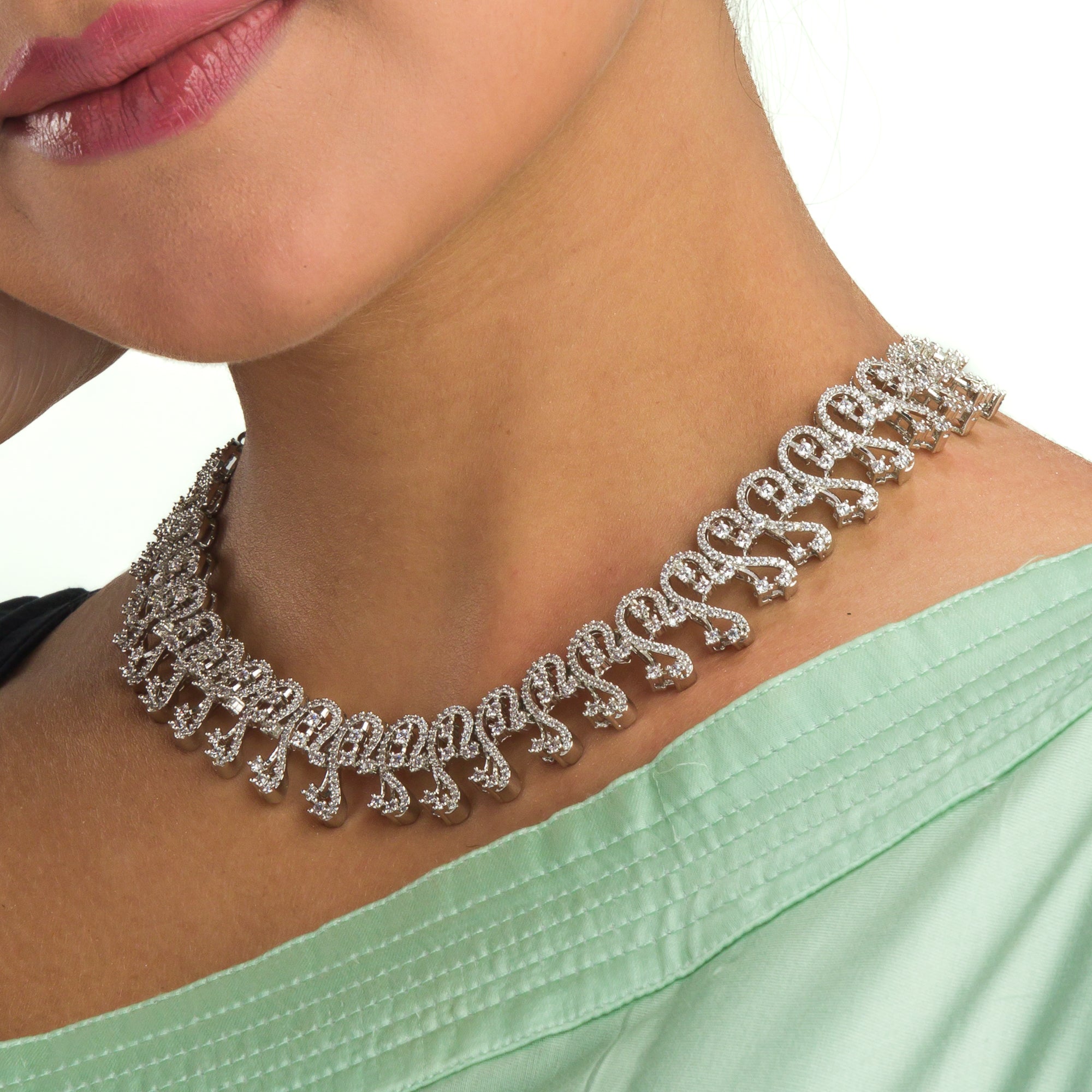 S-shaped zircon design offers sleek, flowing elegance for a refined style.