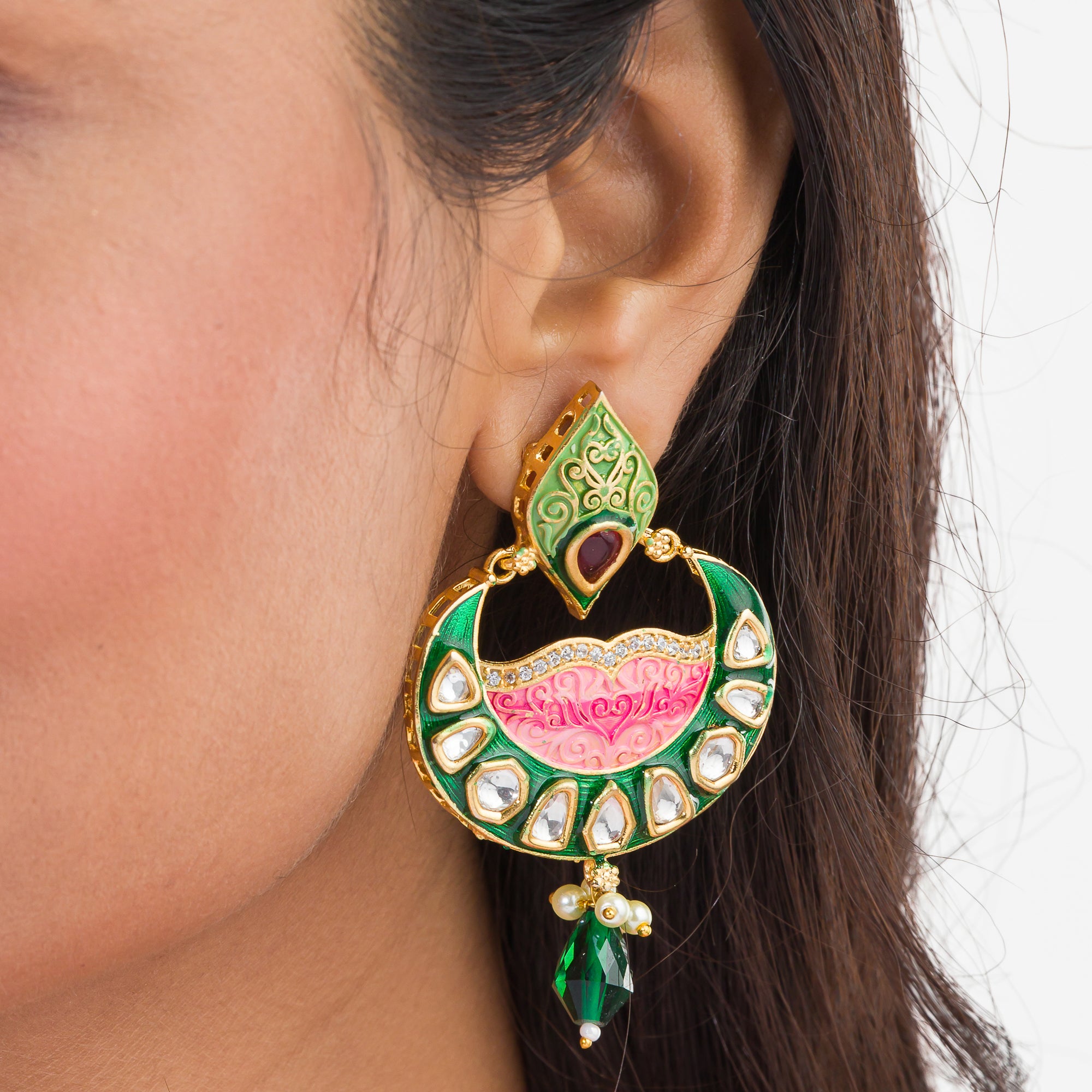 Green and pink Meenakari earrings feature colorful enamel for a traditional look.