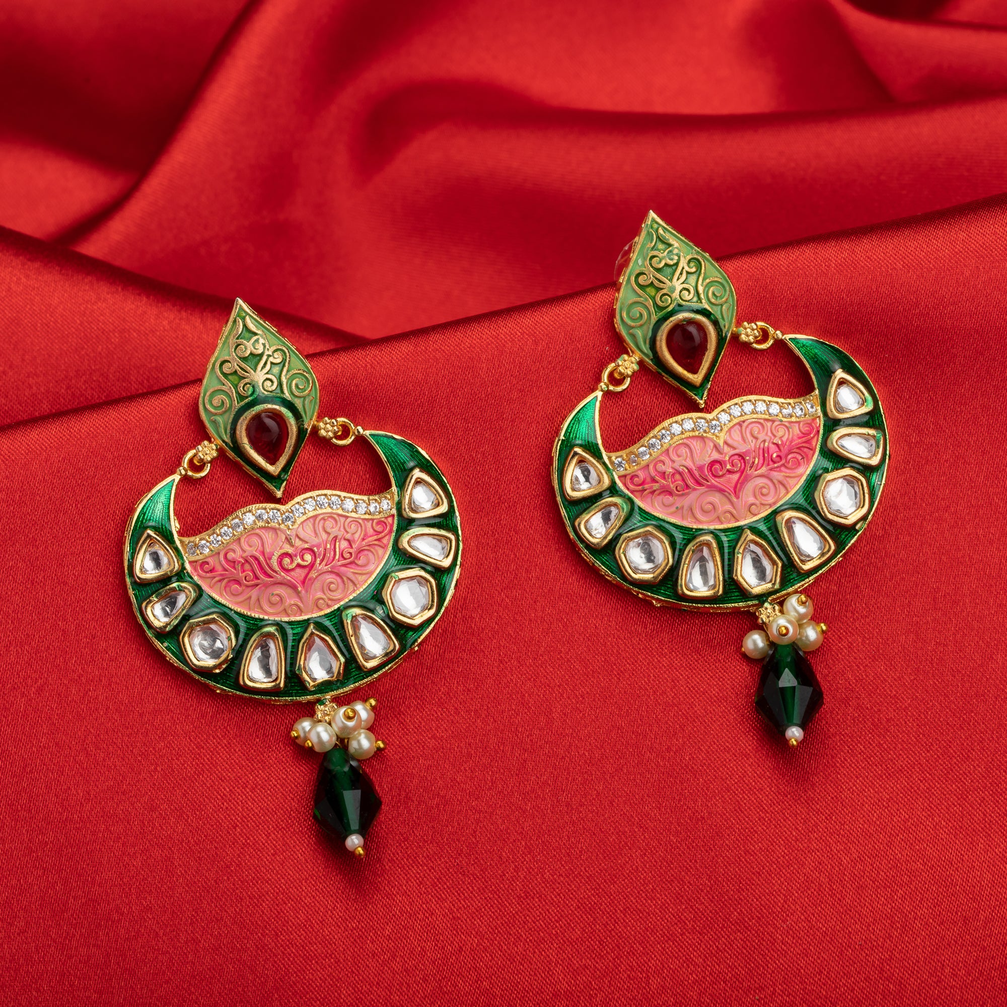 Green and pink Meenakari earrings feature colorful enamel for a traditional look.