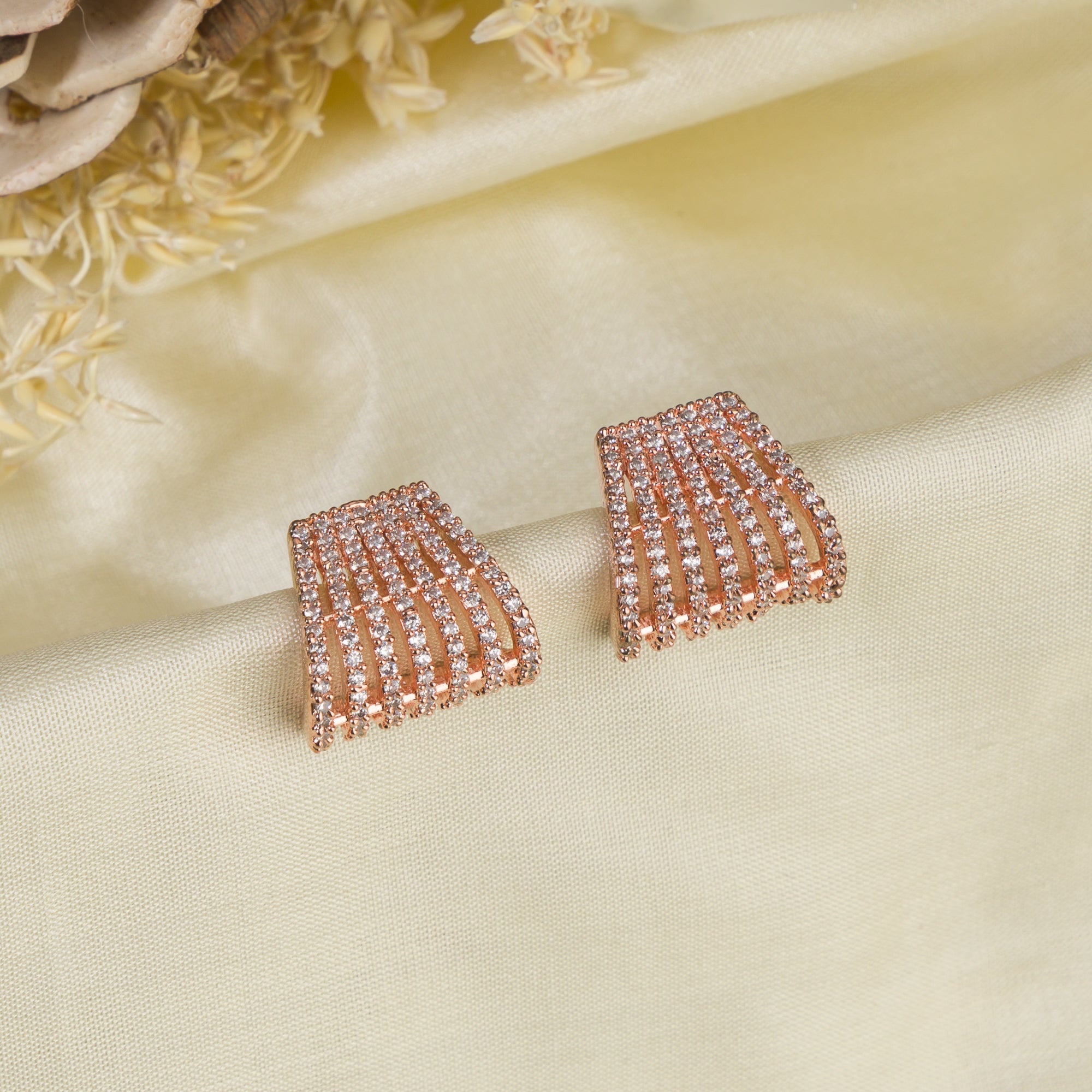 Trendy zircon studs with rose gold polish add a sleek and modern touch.