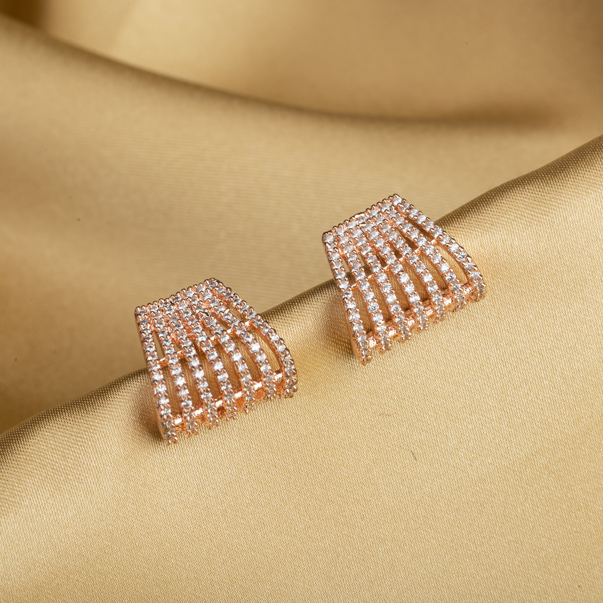 Trendy zircon studs with rose gold polish add a sleek and modern touch.