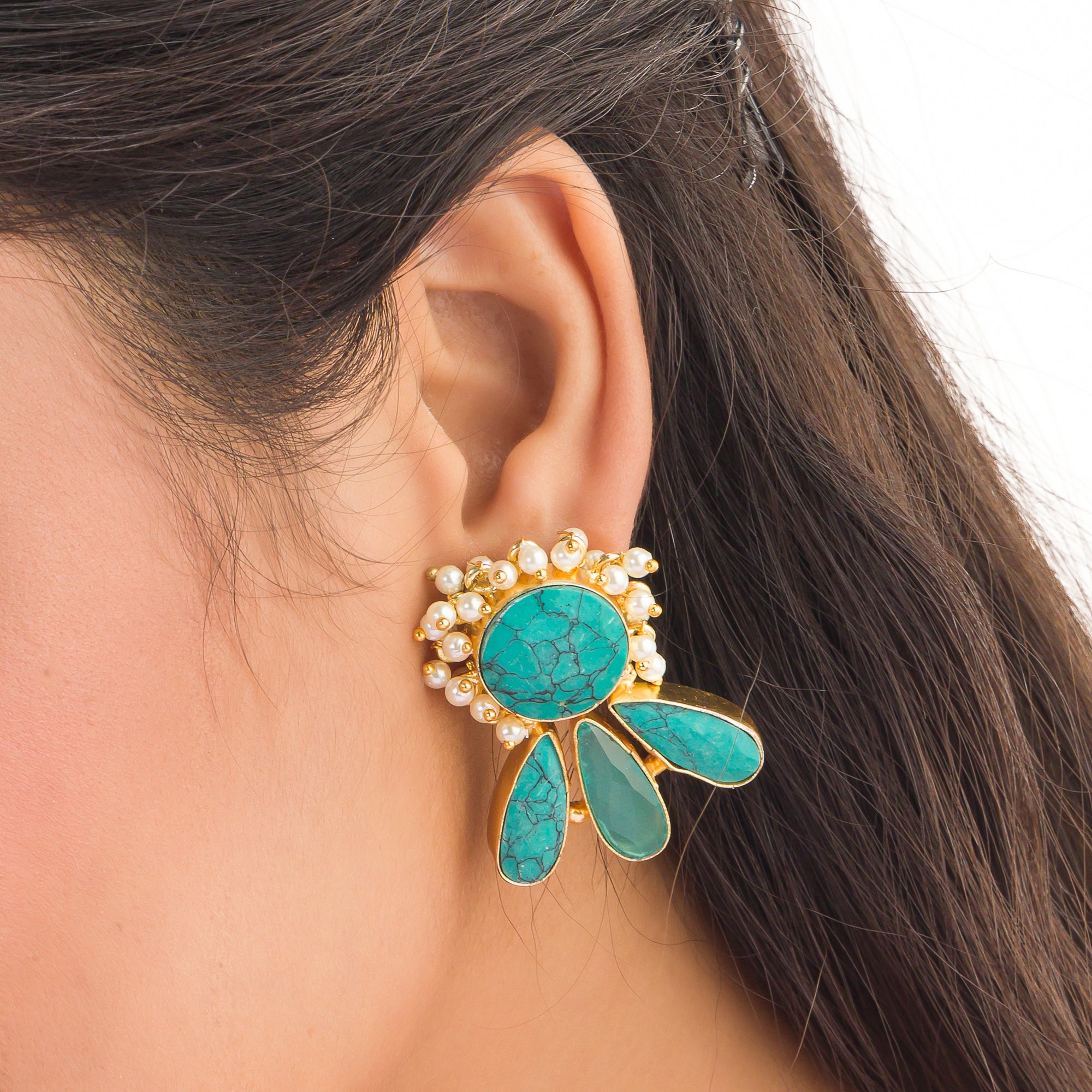 Blue gold-tone earrings with a pearl drop offer classic elegance and vibrant color.