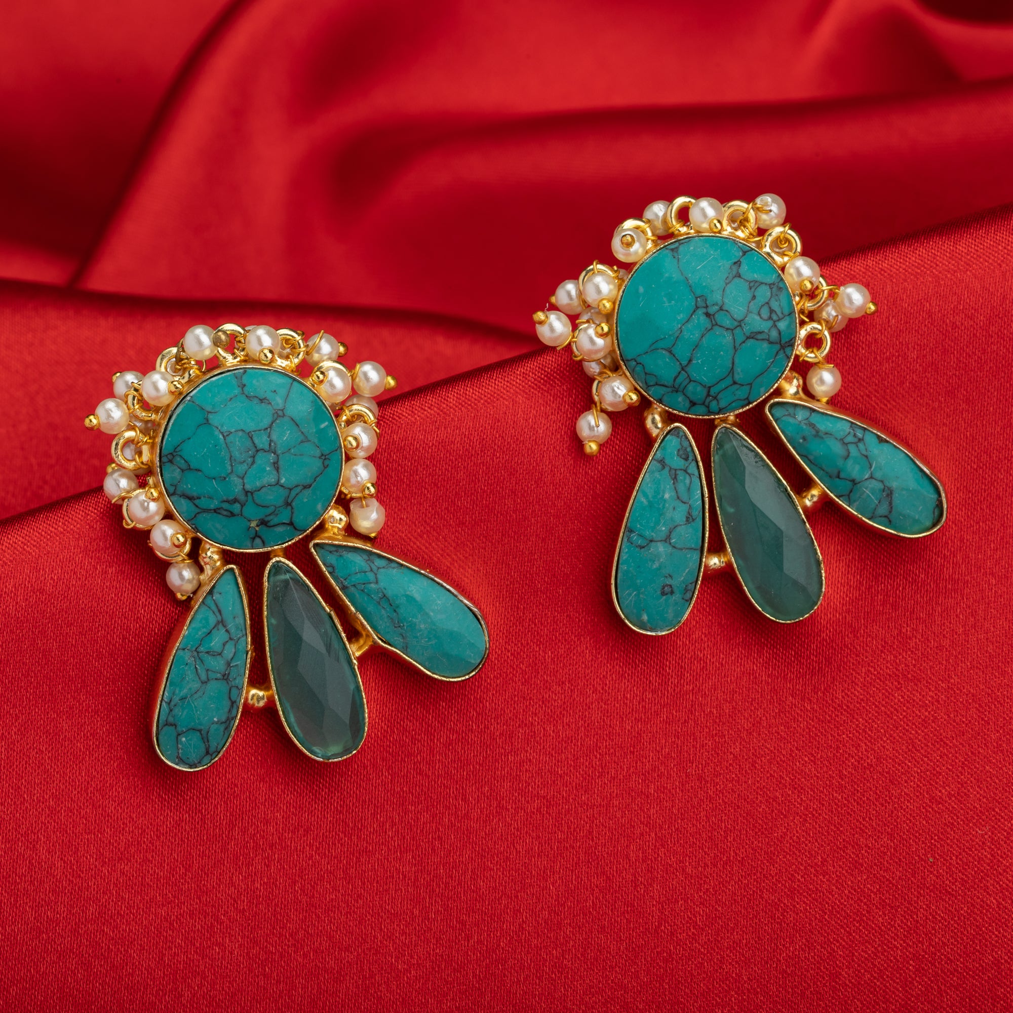 Blue gold-tone earrings with a pearl drop offer classic elegance and vibrant color.