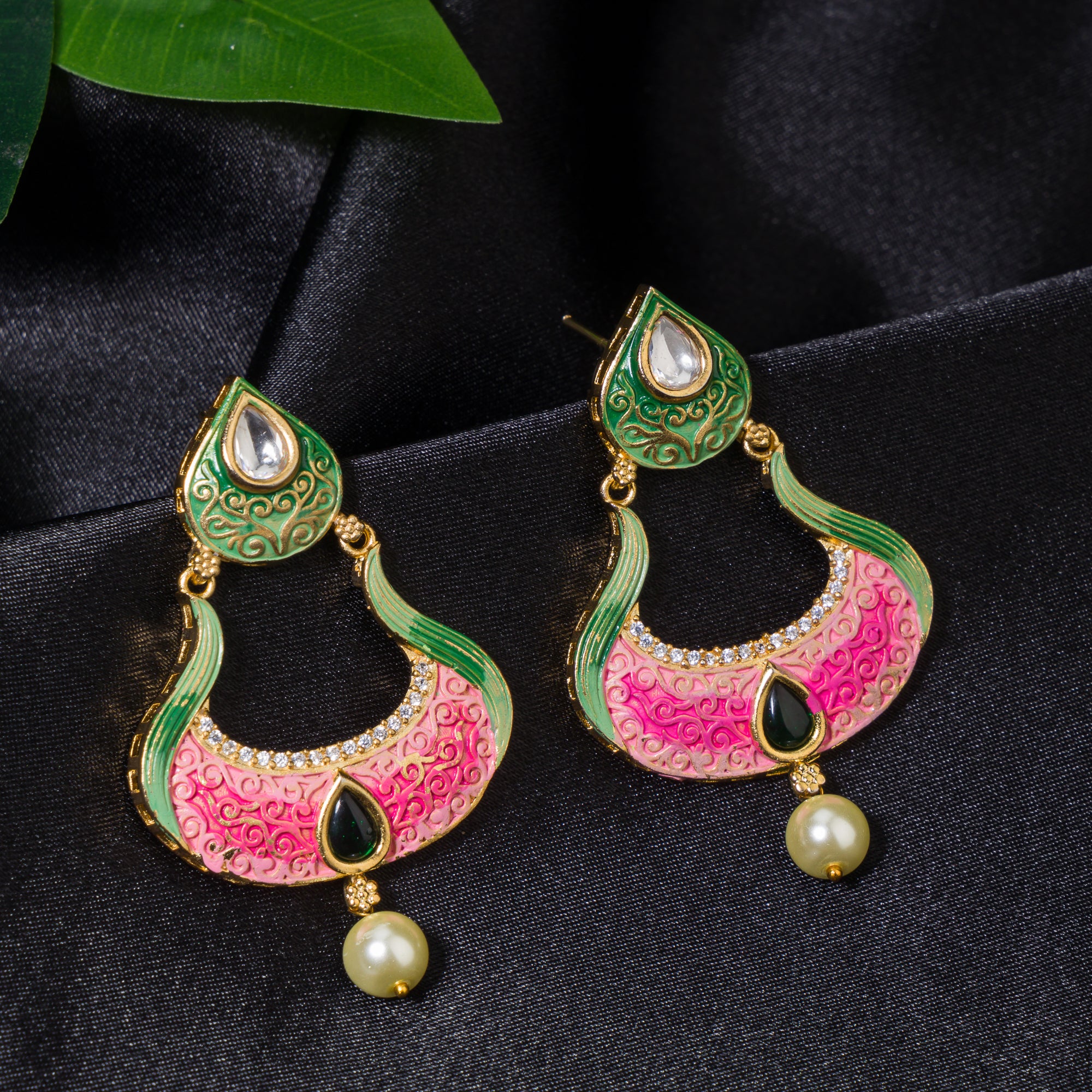 Gold-tone dangler earrings with Meenakari design offer intricate elegance and charm.