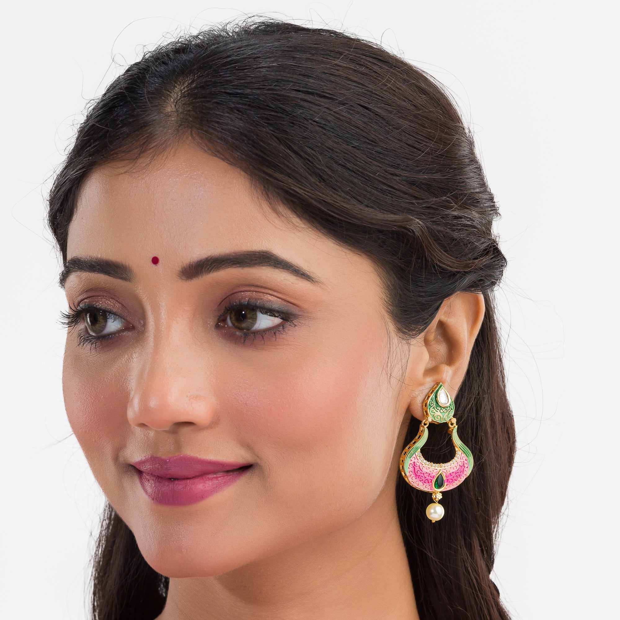 Gold-tone dangler earrings with Meenakari design offer intricate elegance and charm.