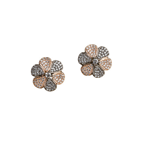 "Zircon flower-shaped earrings with rose gold polish combine warmth and vibrant sparkle."