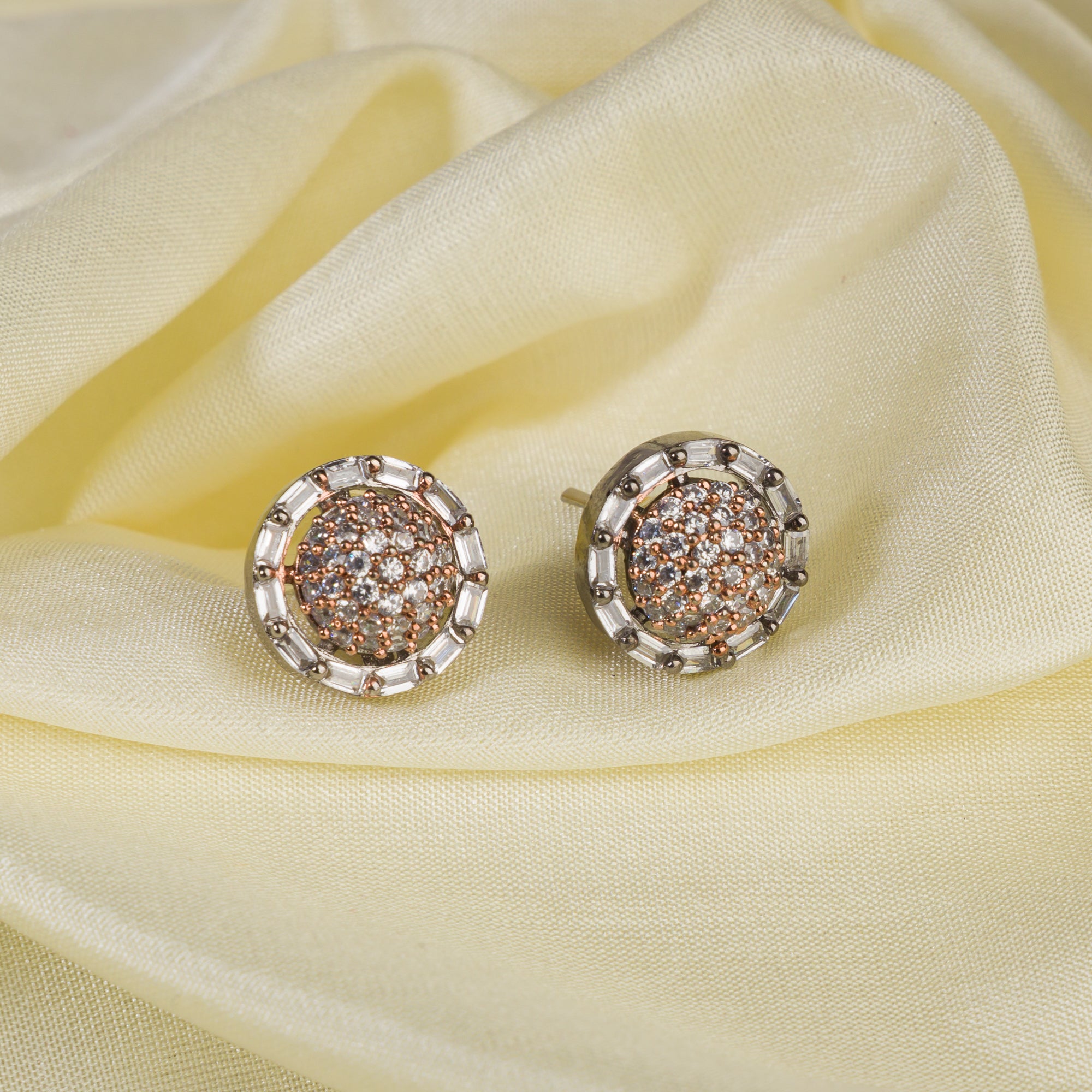 "Silver zircon studs with golden beads bring a subtle, stylish touch to casual elegance."