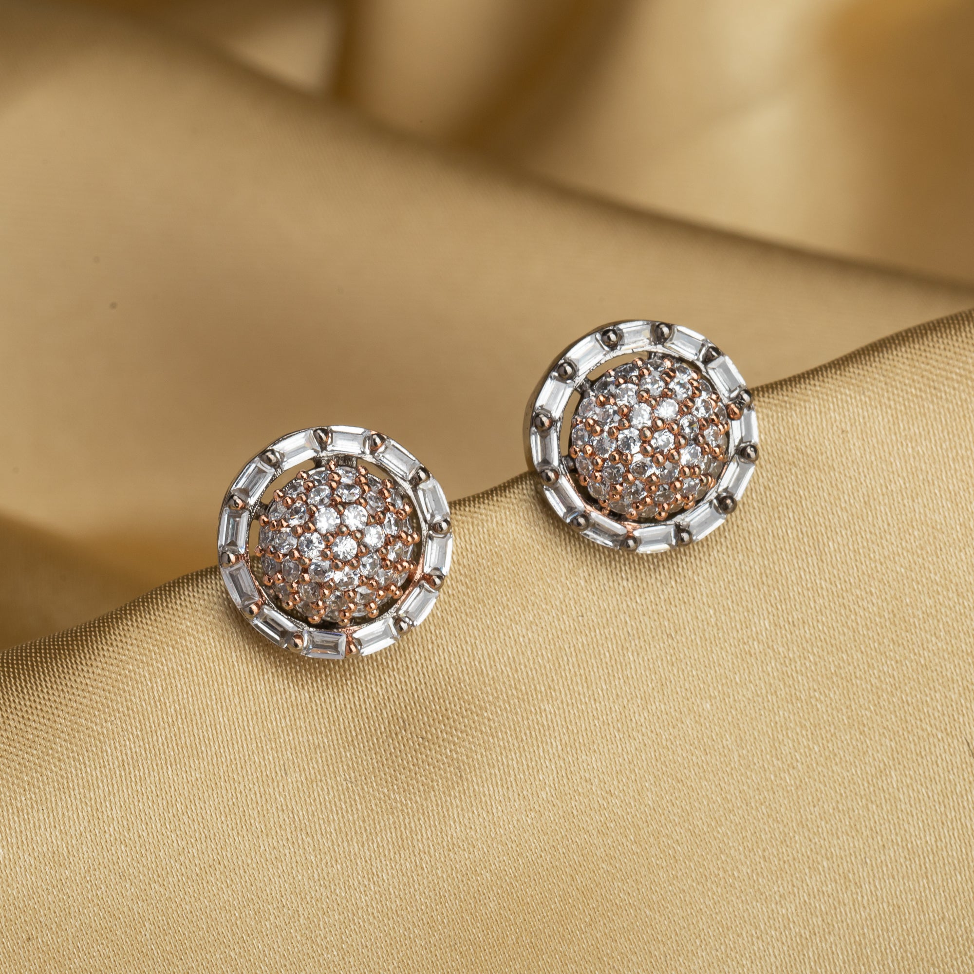 "Silver zircon studs with golden beads bring a subtle, stylish touch to casual elegance."