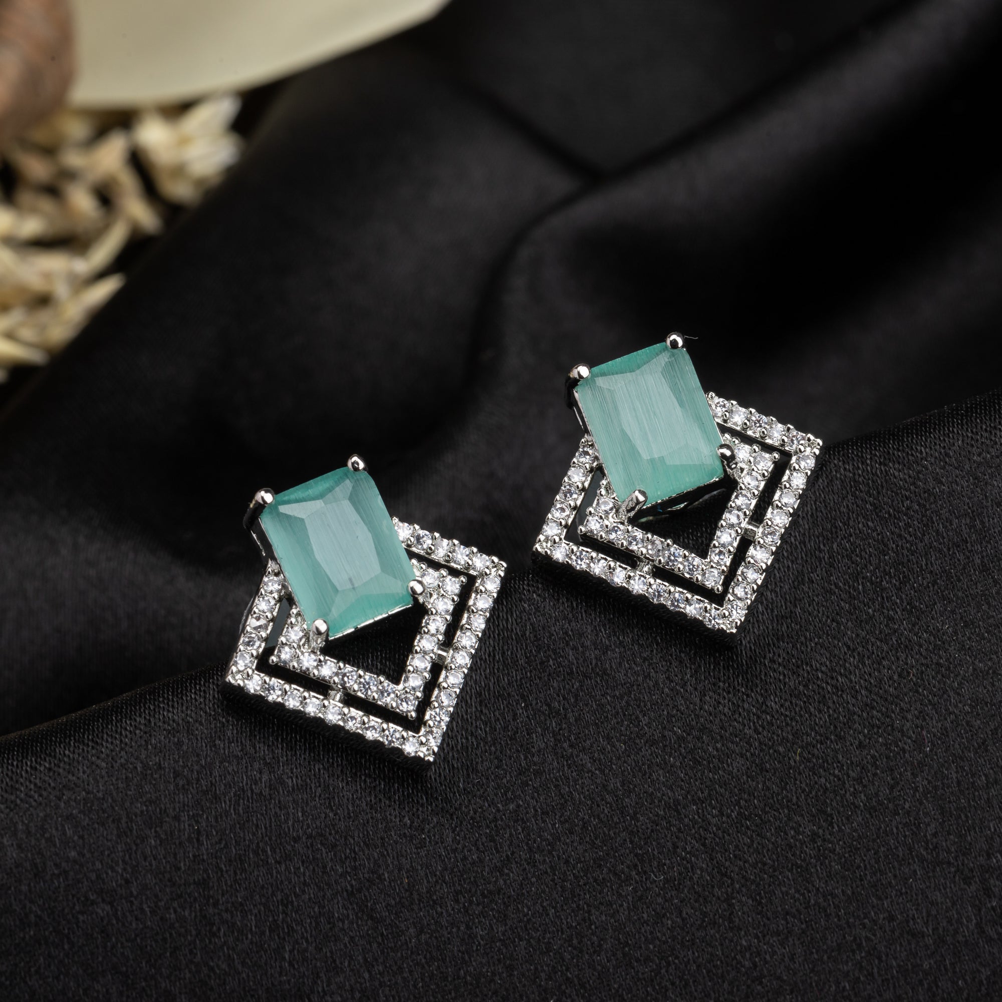 "Light green zircon studs sparkle with elegance, adding vibrant color to your casual look."