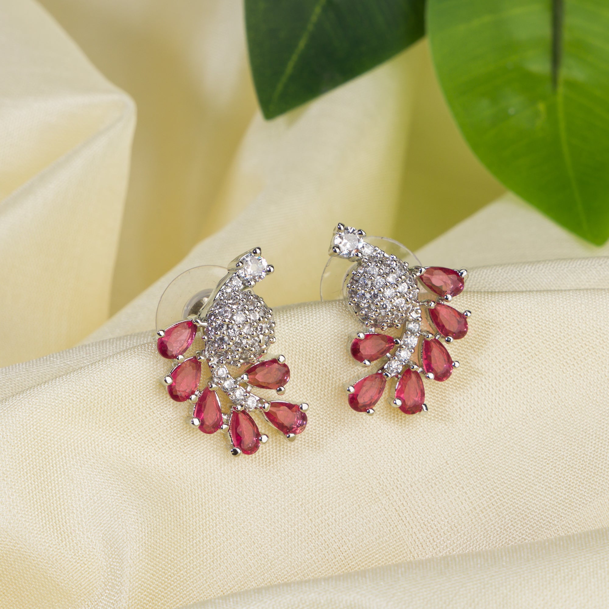 "Peacock-shaped pink zircon studs combine vibrant color with unique, elegant charm."