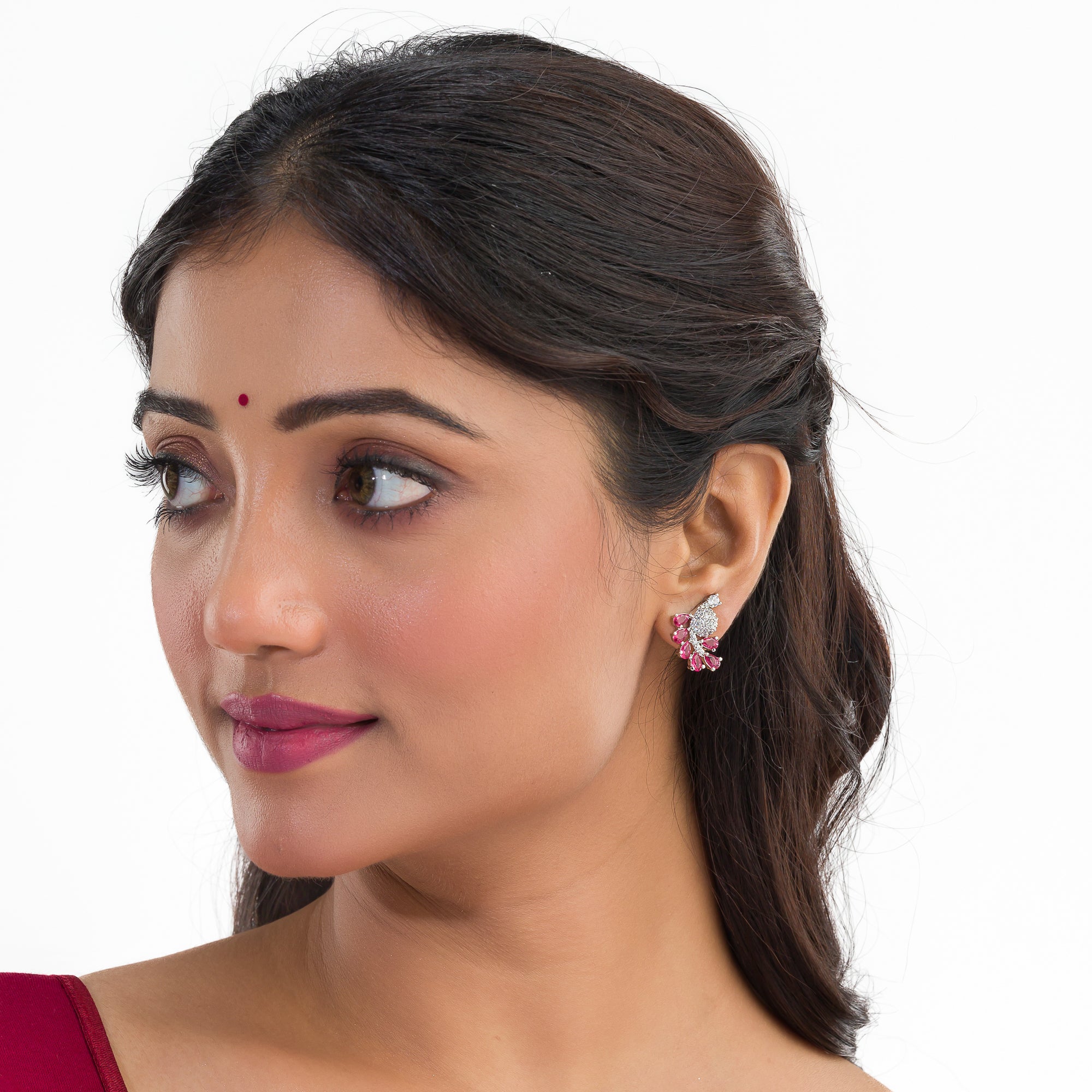 "Peacock-shaped pink zircon studs combine vibrant color with unique, elegant charm."