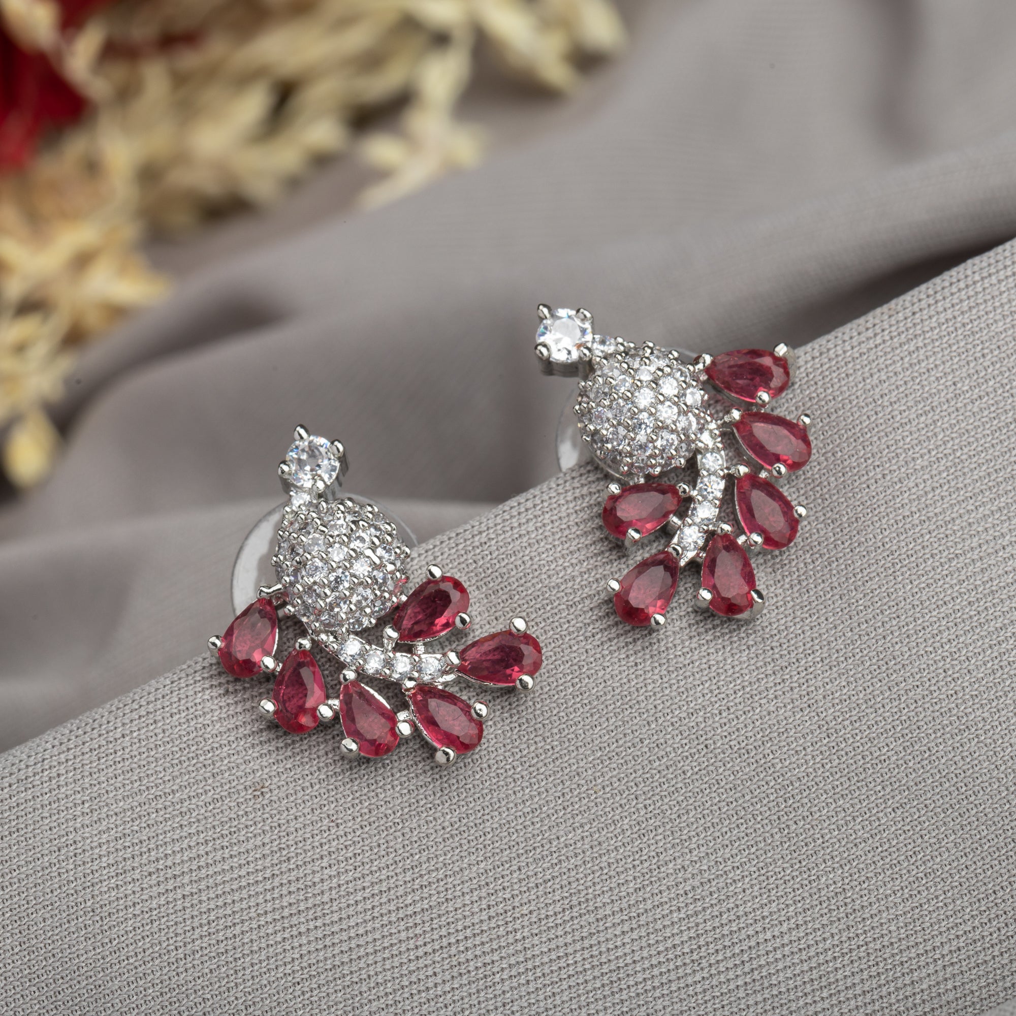 "Peacock-shaped pink zircon studs combine vibrant color with unique, elegant charm."
