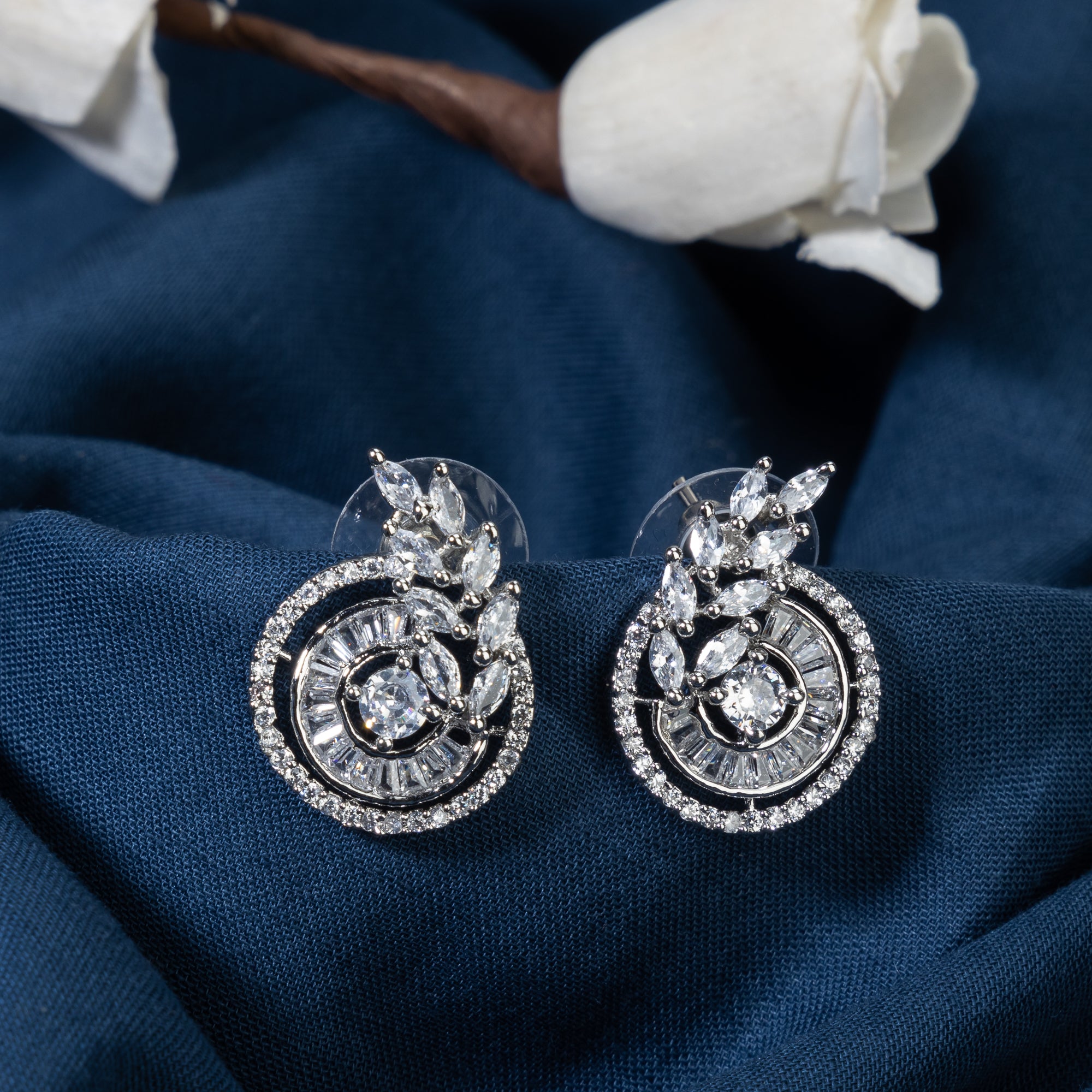 "Round and leaf zircon earrings combine sparkling beauty with nature-inspired, elegant charm."
