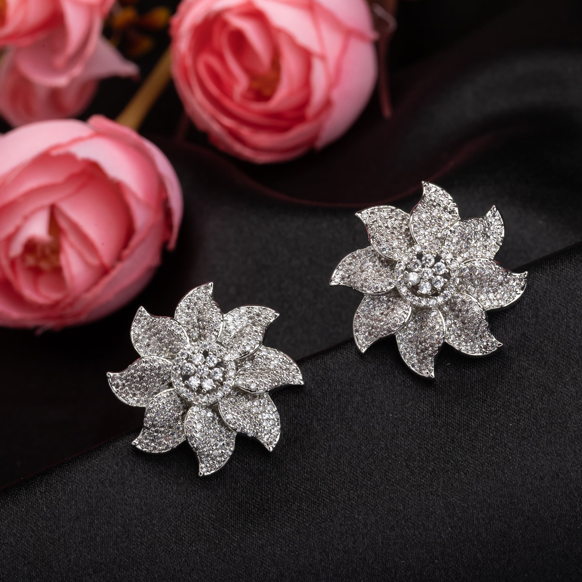 Flowery zircon stud earrings offer charming elegance with sparkling grace for a refined look.