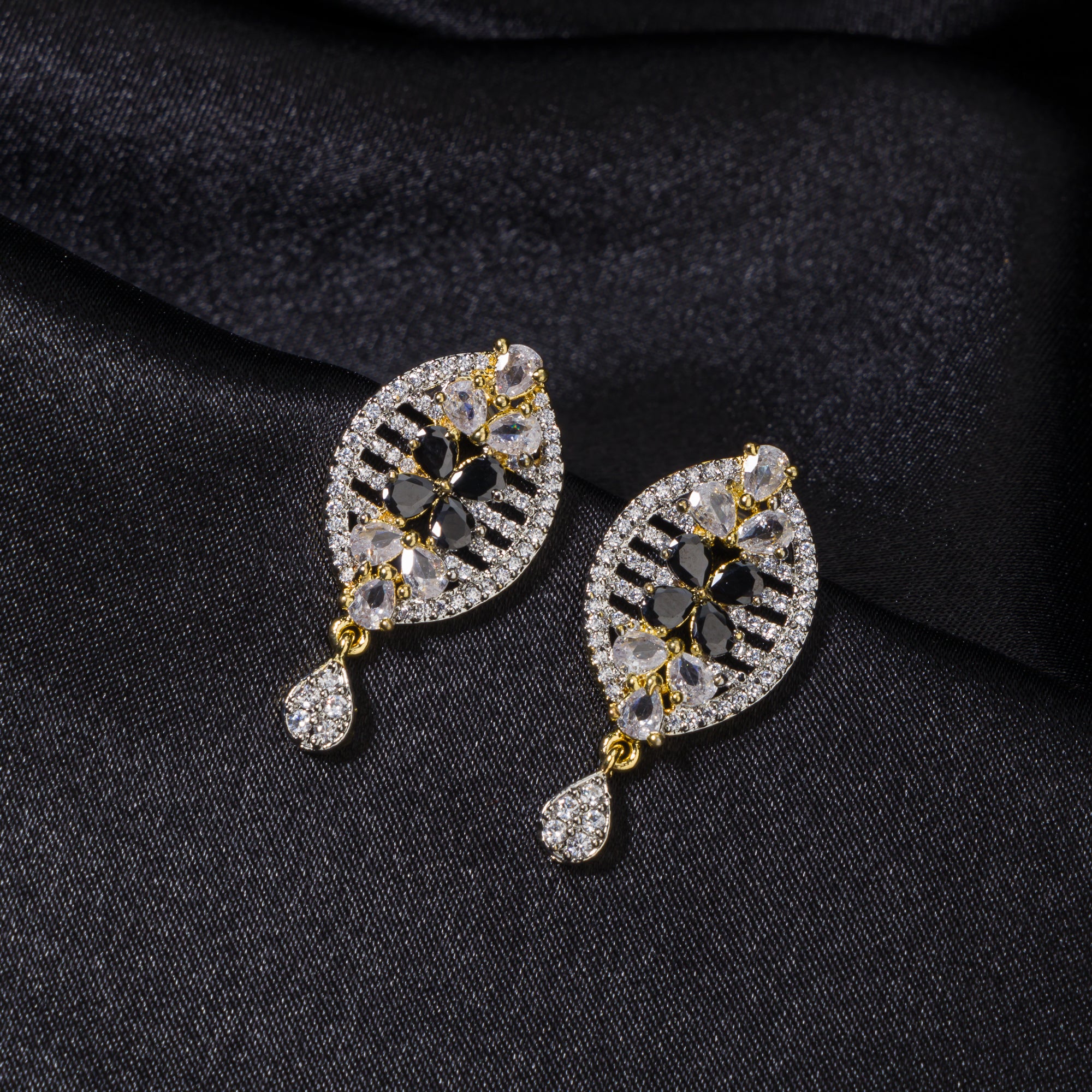 "Zircon earrings with a golden touch combine sparkling brilliance and a warm, luxurious finish."