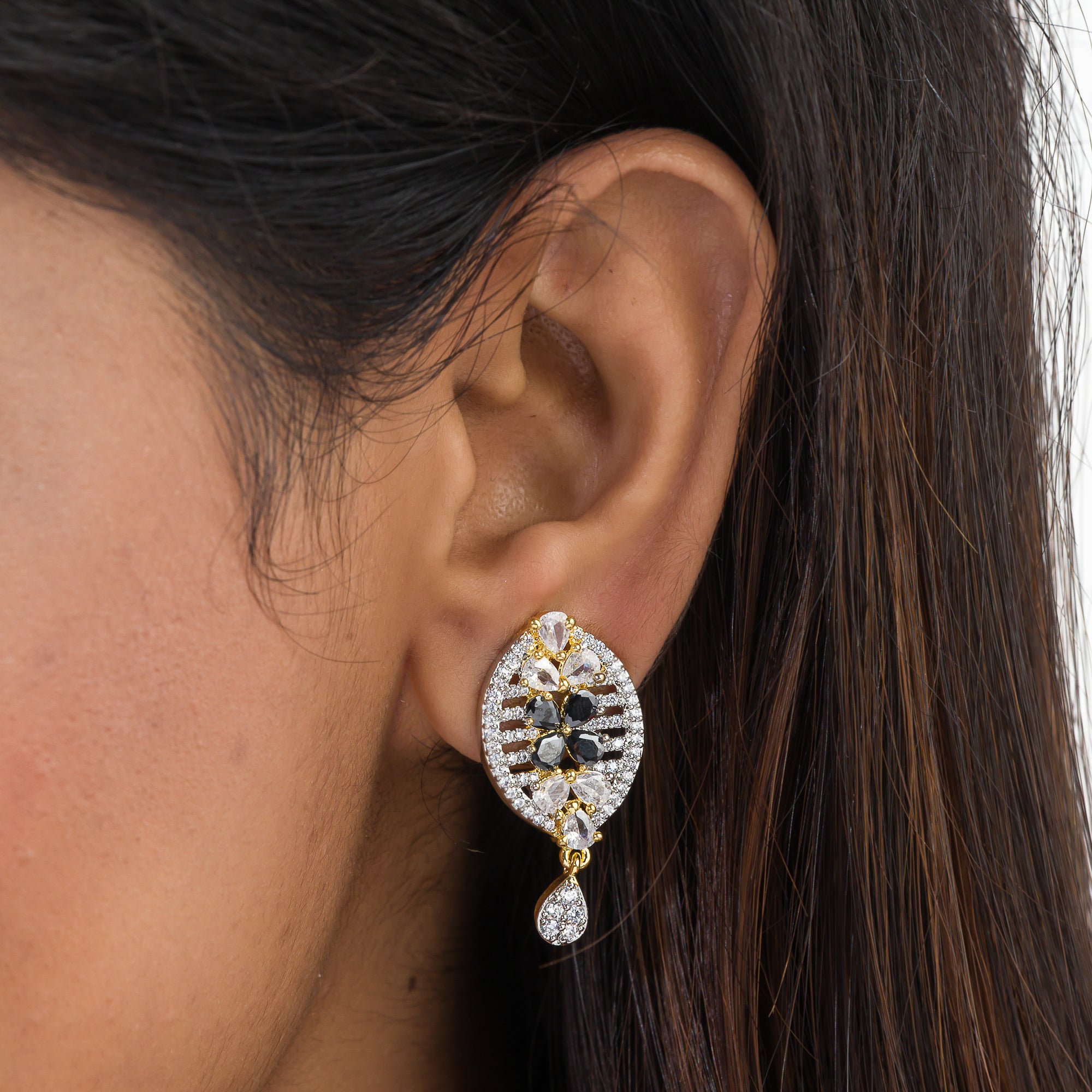 "Zircon earrings with a golden touch combine sparkling brilliance and a warm, luxurious finish."