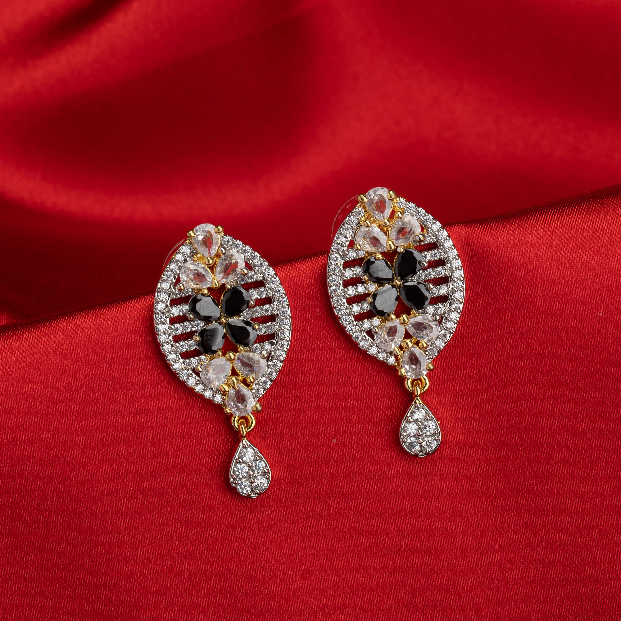 "Zircon earrings with a golden touch combine sparkling brilliance and a warm, luxurious finish."