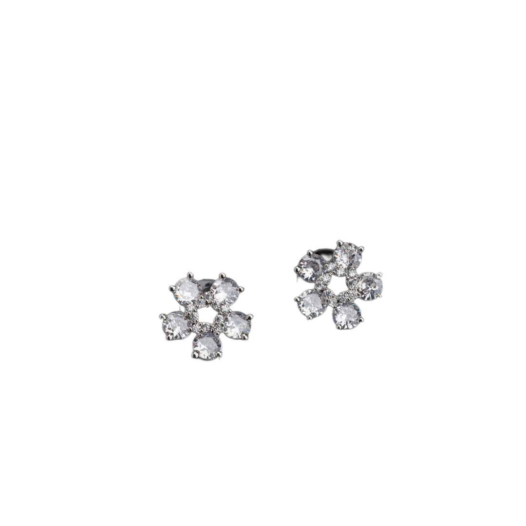"Small flower-shaped zircon earrings offer subtle charm and elegant sparkle for a refined, timeless look."