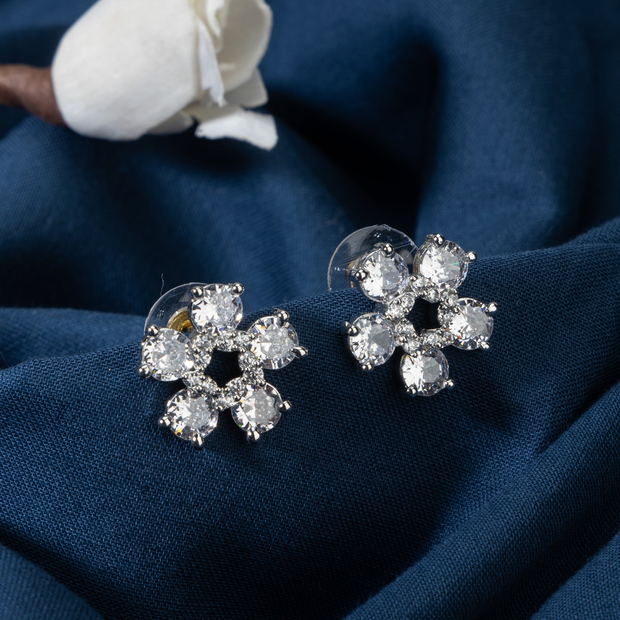 "Small flower-shaped zircon earrings offer subtle charm and elegant sparkle for a refined, timeless look."