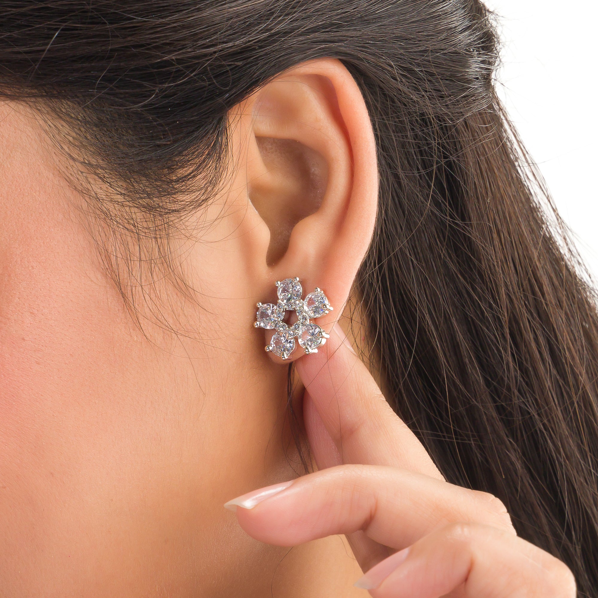 "Small flower-shaped zircon earrings offer subtle charm and elegant sparkle for a refined, timeless look."