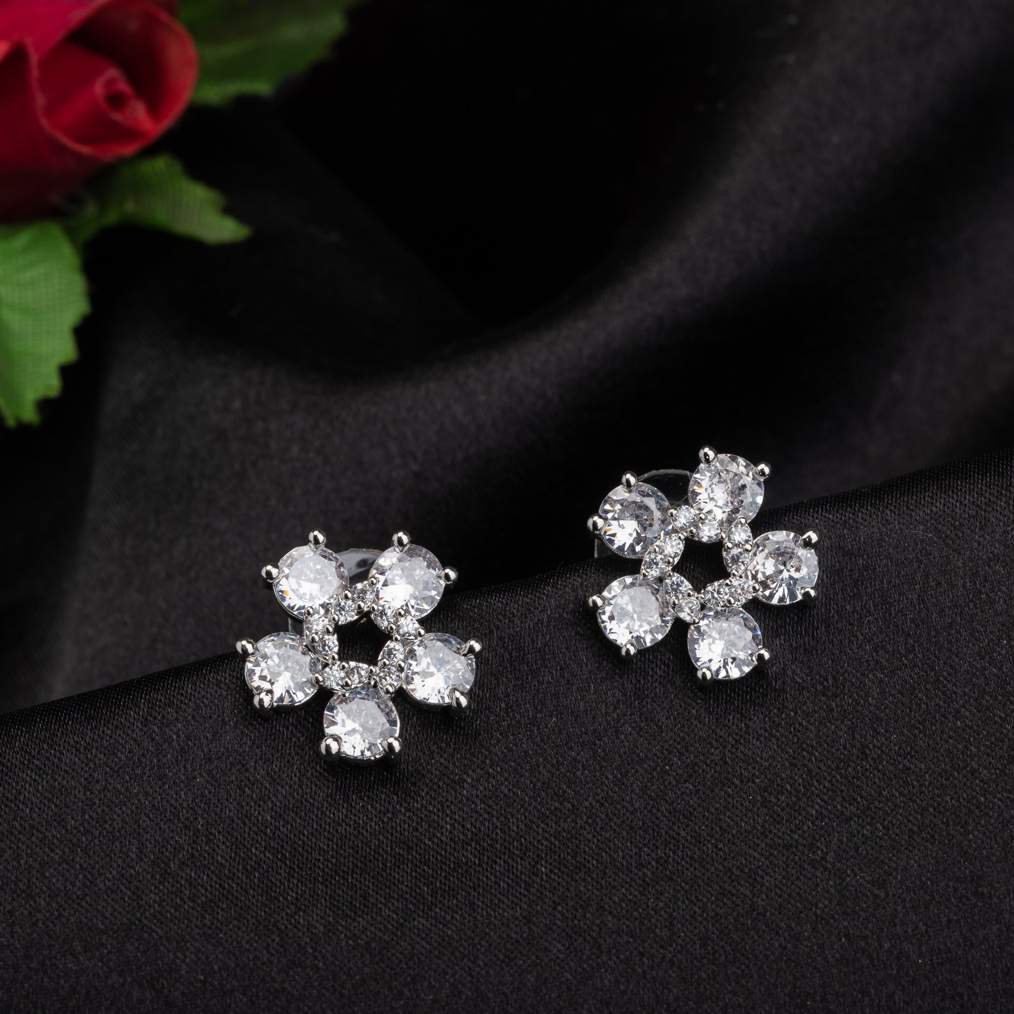 "Small flower-shaped zircon earrings offer subtle charm and elegant sparkle for a refined, timeless look."