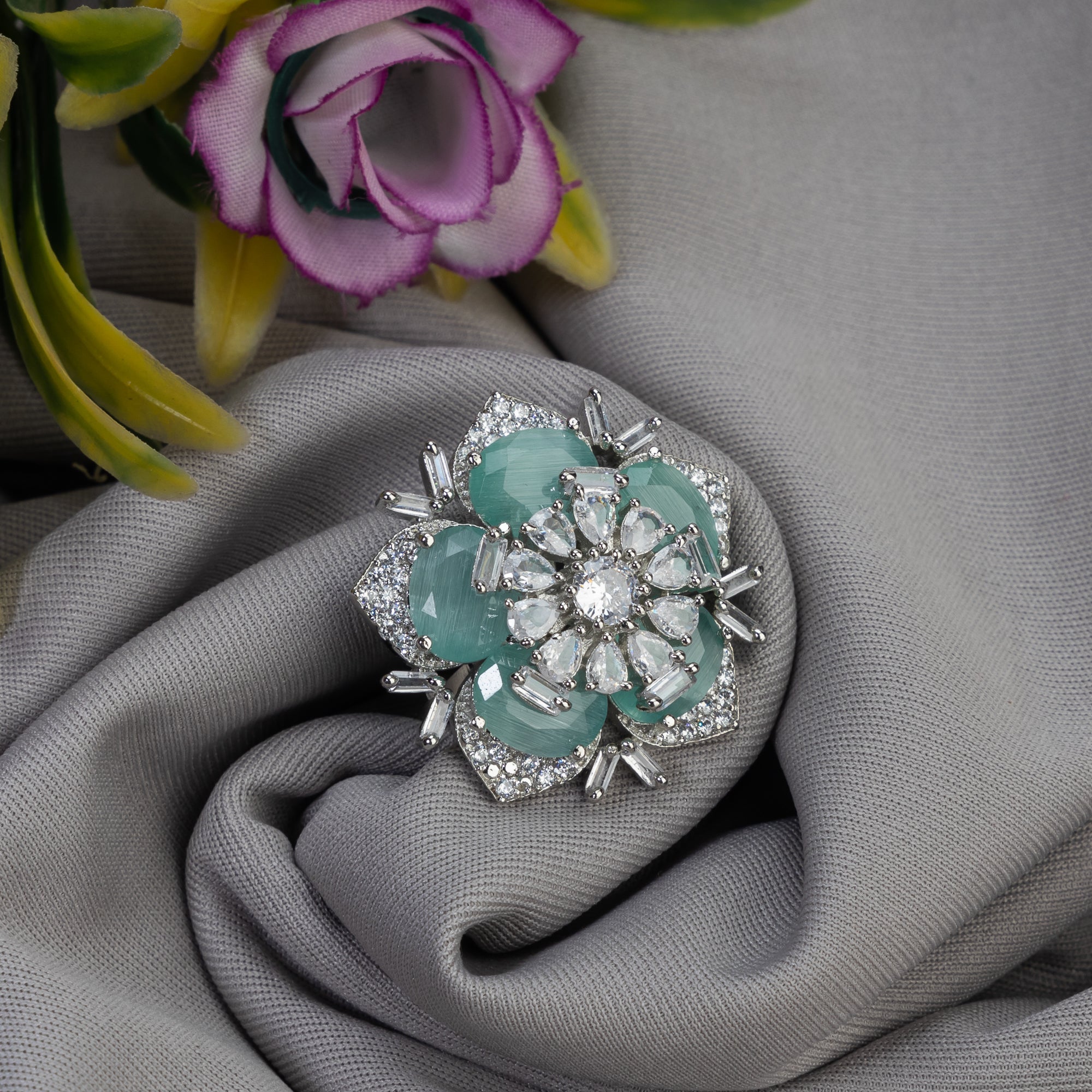 Silver zircon finger ring with turquoise stone offers vibrant charm and sparkling brilliance.