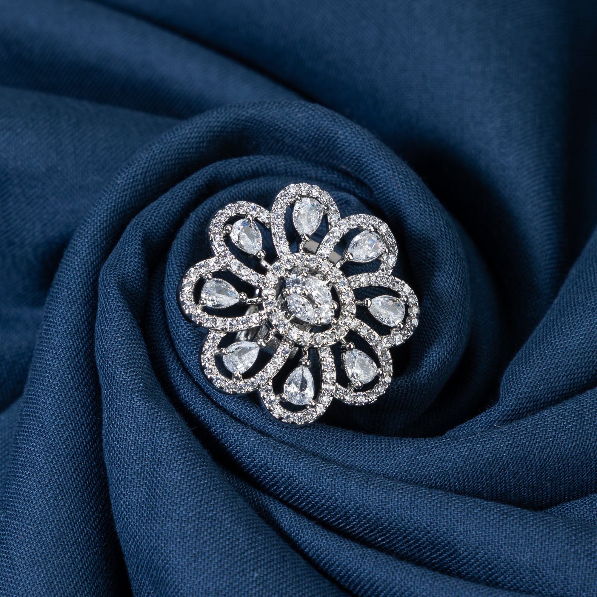 Silver floral zircon finger ring combines timeless beauty with sparkling brilliance.