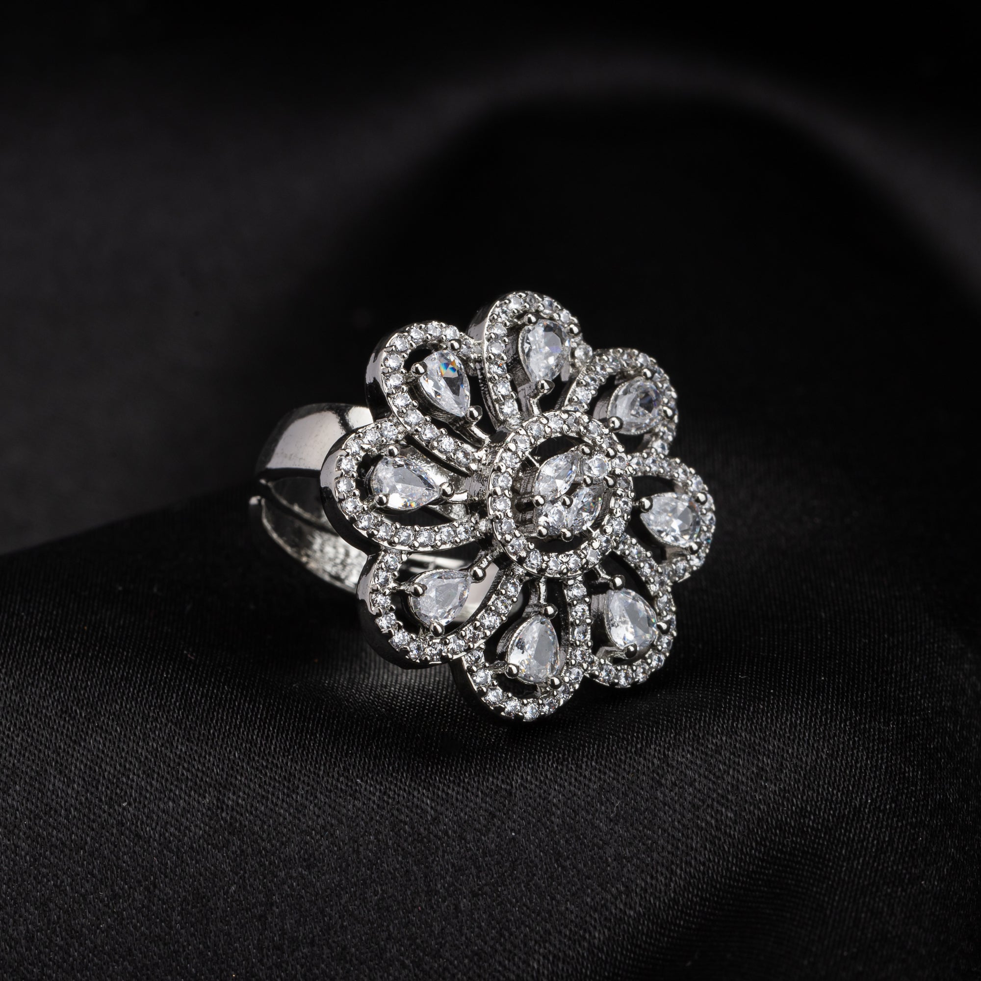 Silver floral zircon finger ring combines timeless beauty with sparkling brilliance.