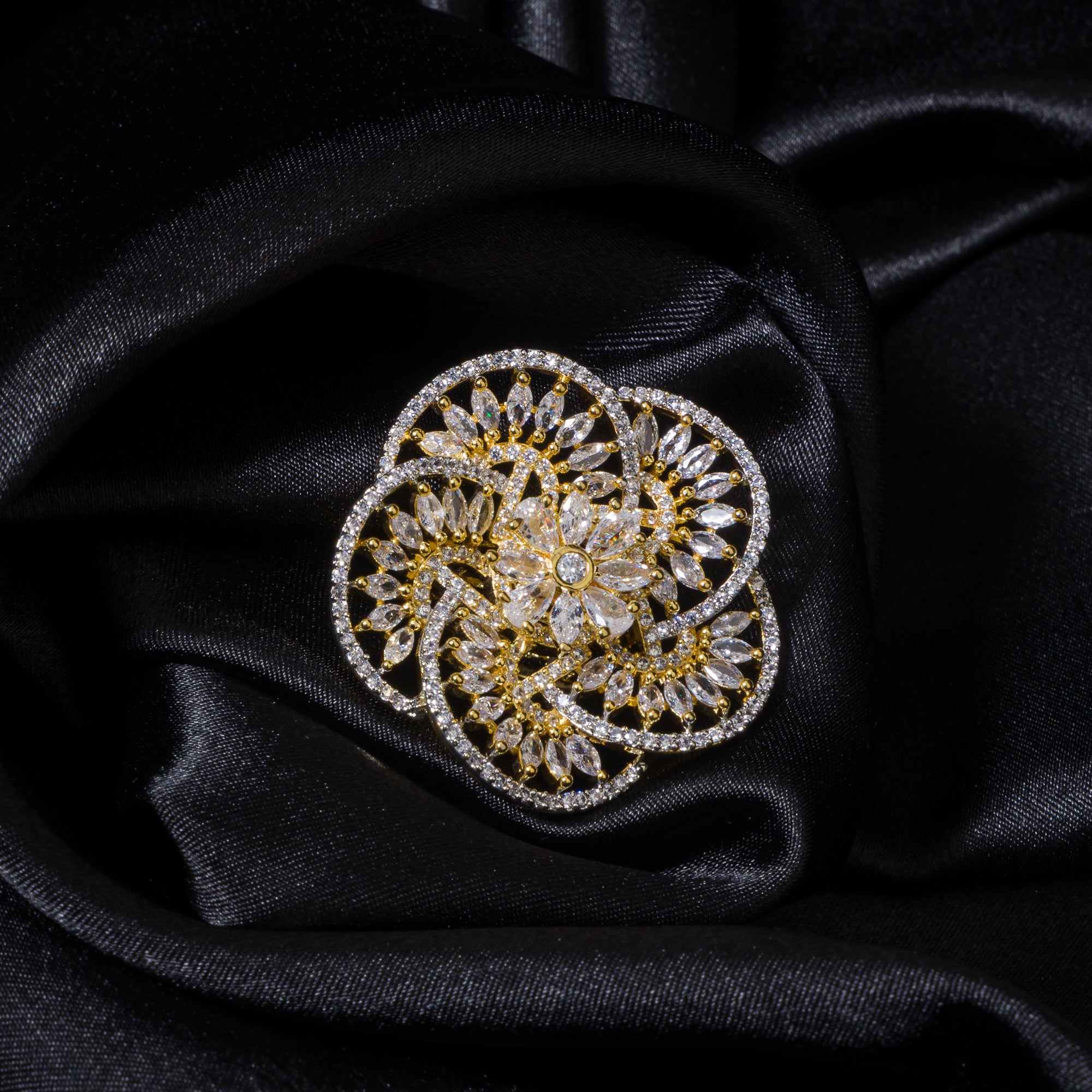 Gold-tone zircon finger ring combines dazzling sparkle with timeless elegance.