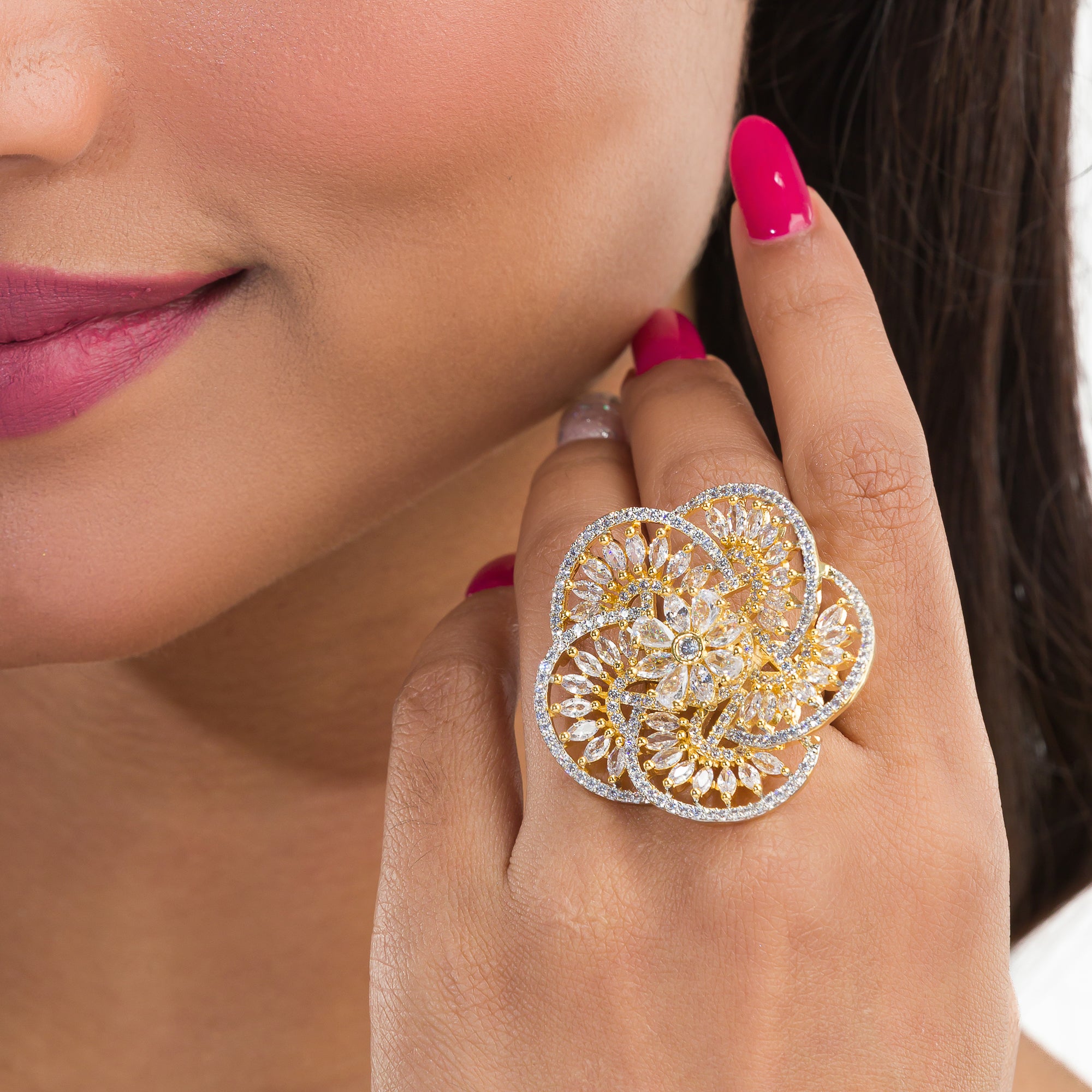 Gold-tone zircon finger ring combines dazzling sparkle with timeless elegance.