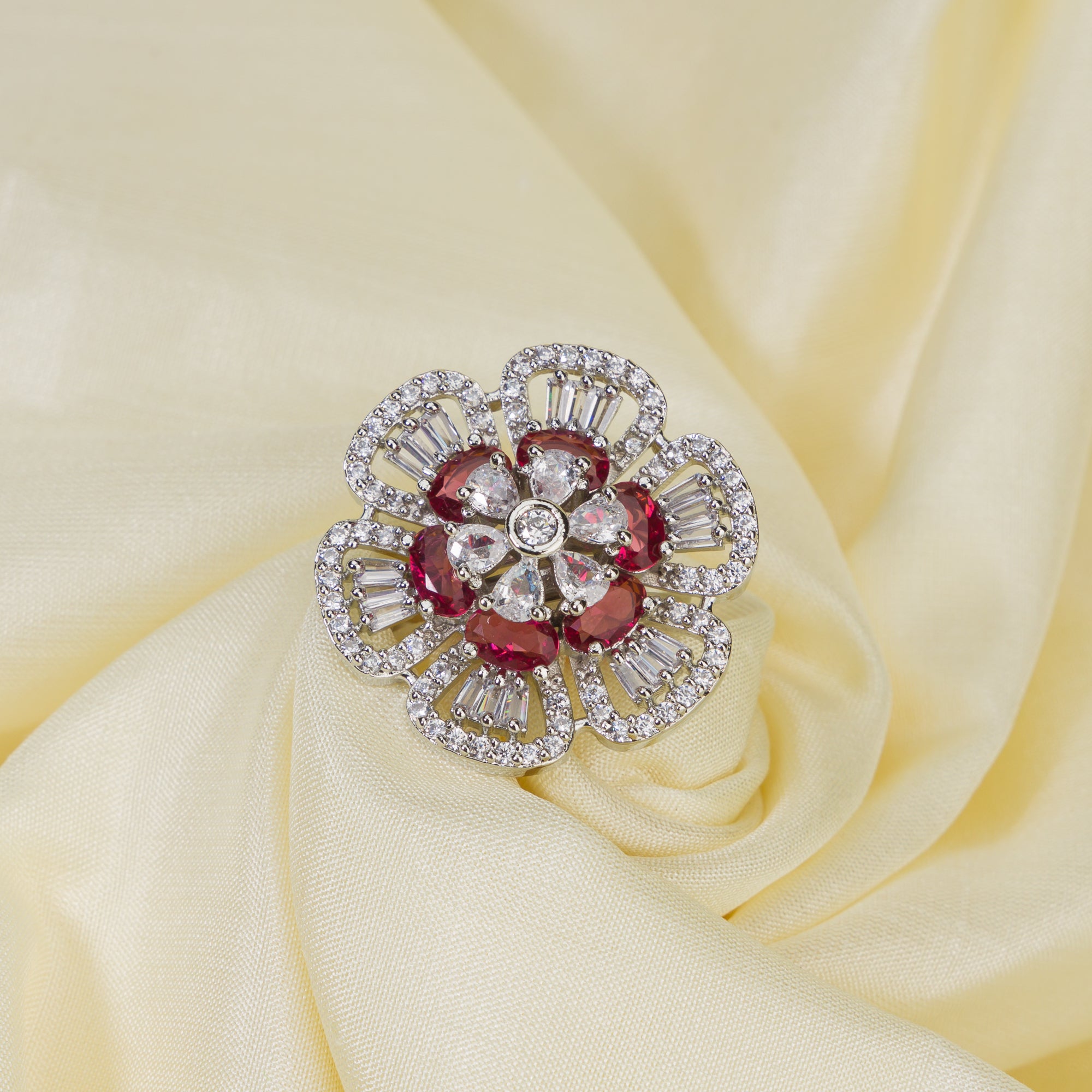 Red zircon finger ring in silver offers a bold and vibrant touch for party occasions.