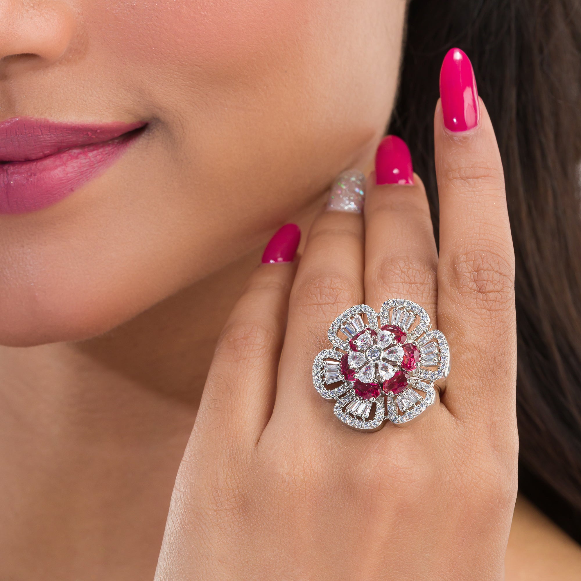 Red zircon finger ring in silver offers a bold and vibrant touch for party occasions.