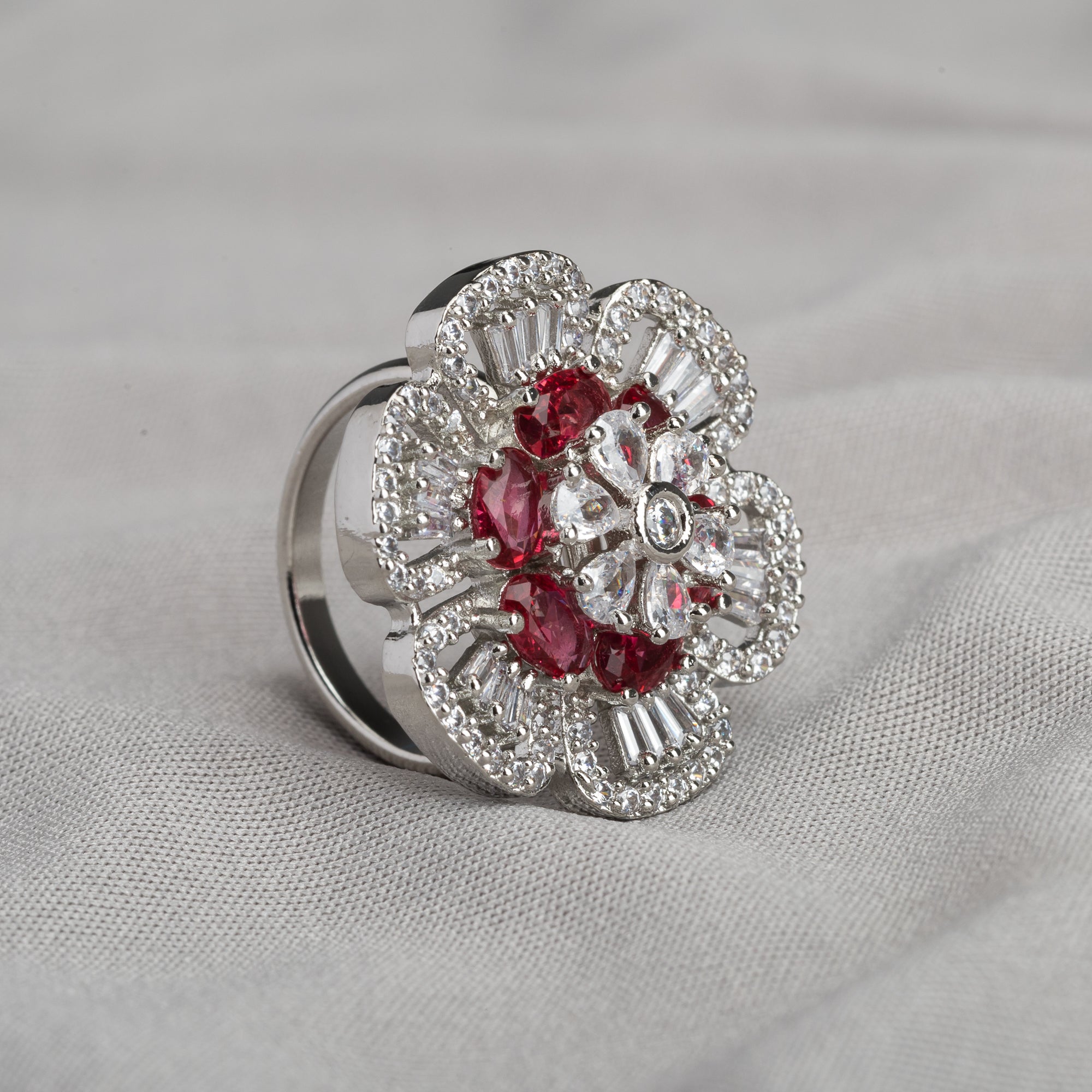 Red zircon finger ring in silver offers a bold and vibrant touch for party occasions.